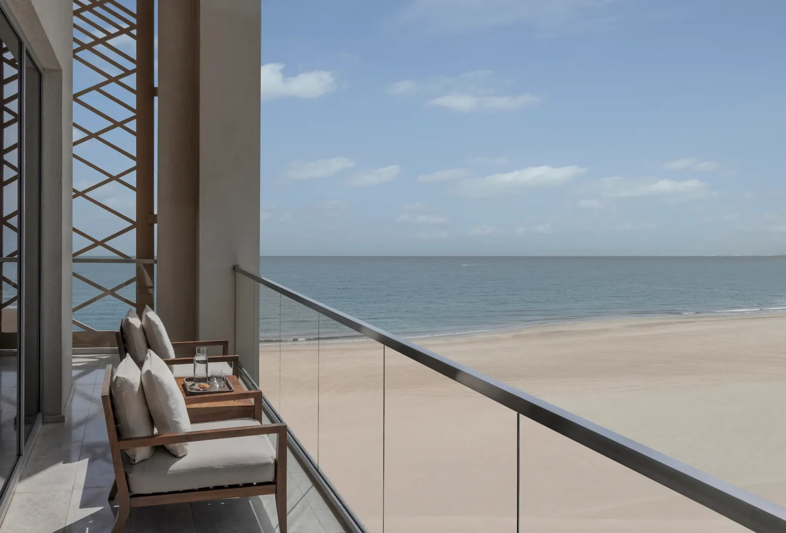 kempinski hotel muscat muscat grand deluxe sea view room balcony with panoramic sea views and outdoor seating