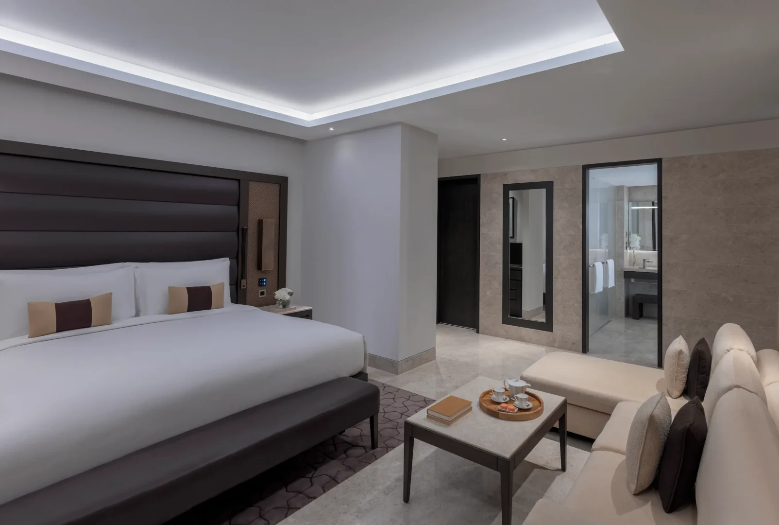 kempinski hotel muscat muscat grand deluxe resort view room bedroom with elegant furnishings and relaxing resort views