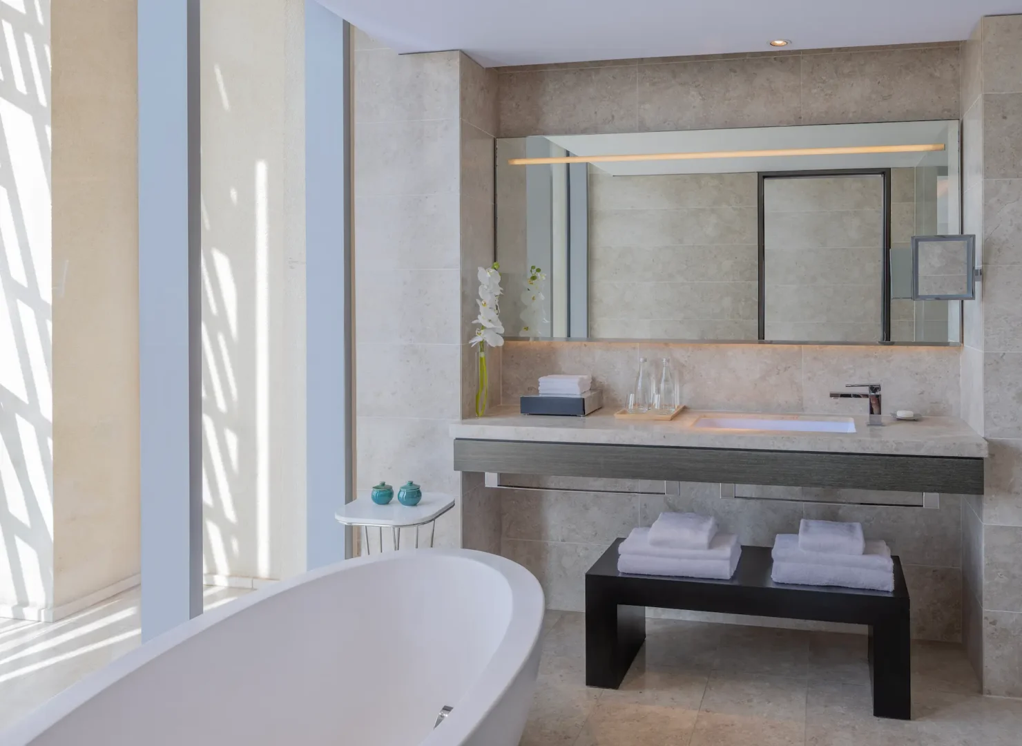 kempinski hotel muscat muscat grand deluxe sea view and junior suite bathroom with elegant vanity and contemporary luxury design