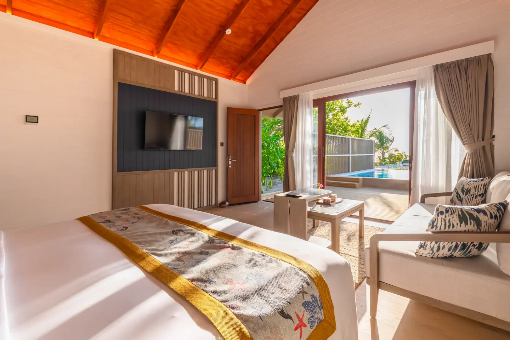 meeru maldives beach pool villa interior featuring elegant design, natural textures and a serene tropical atmosphere with direct access to private outdoor space