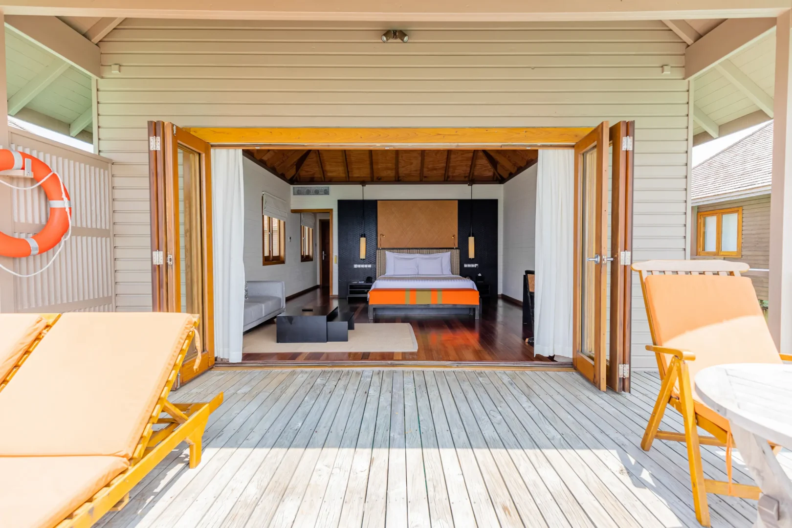 meeru maldives ocean villa bedroom featuring elegant interiors, natural textures and panoramic views across the turquoise lagoon in a serene island setting