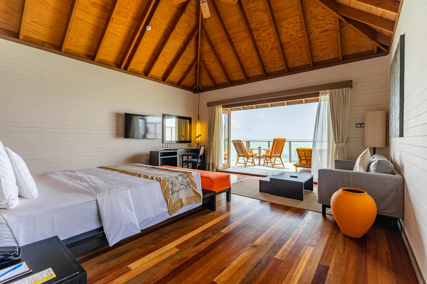 meeru maldives ocean villa bedroom interior featuring elegant design, natural textures and serene views across the turquoise lagoon in a tranquil island setting