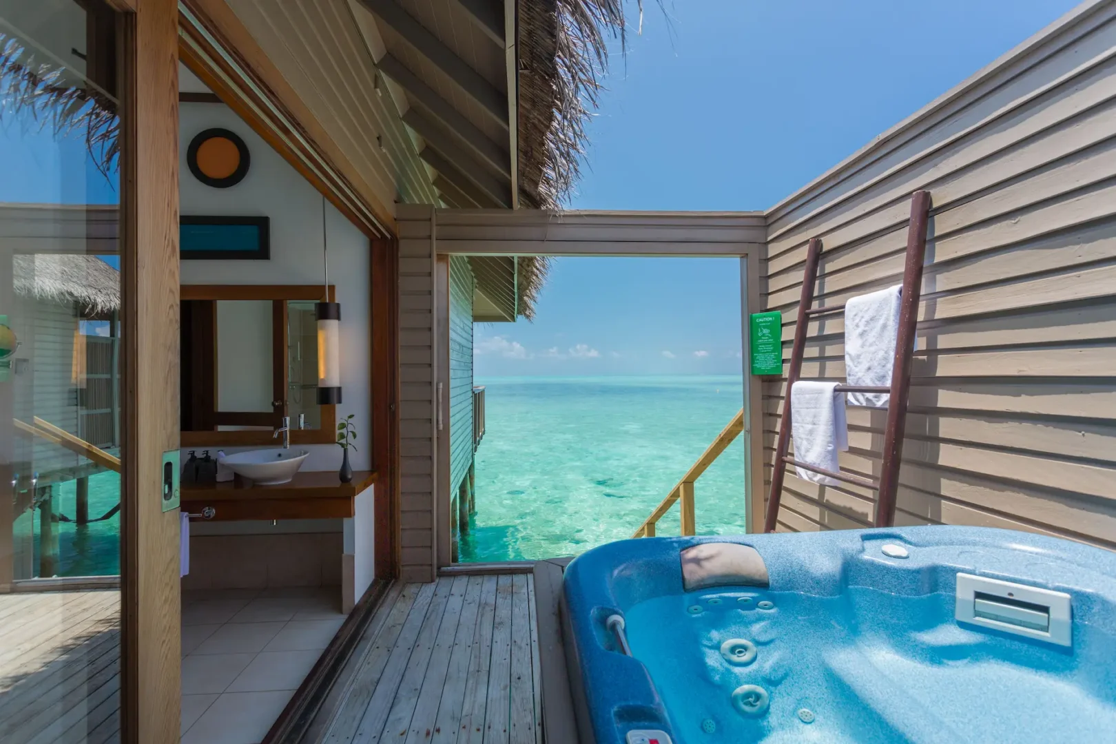 meeru maldives ocean villa jacuzzi with direct ocean access set on a private deck overlooking turquoise lagoon in a tranquil island setting