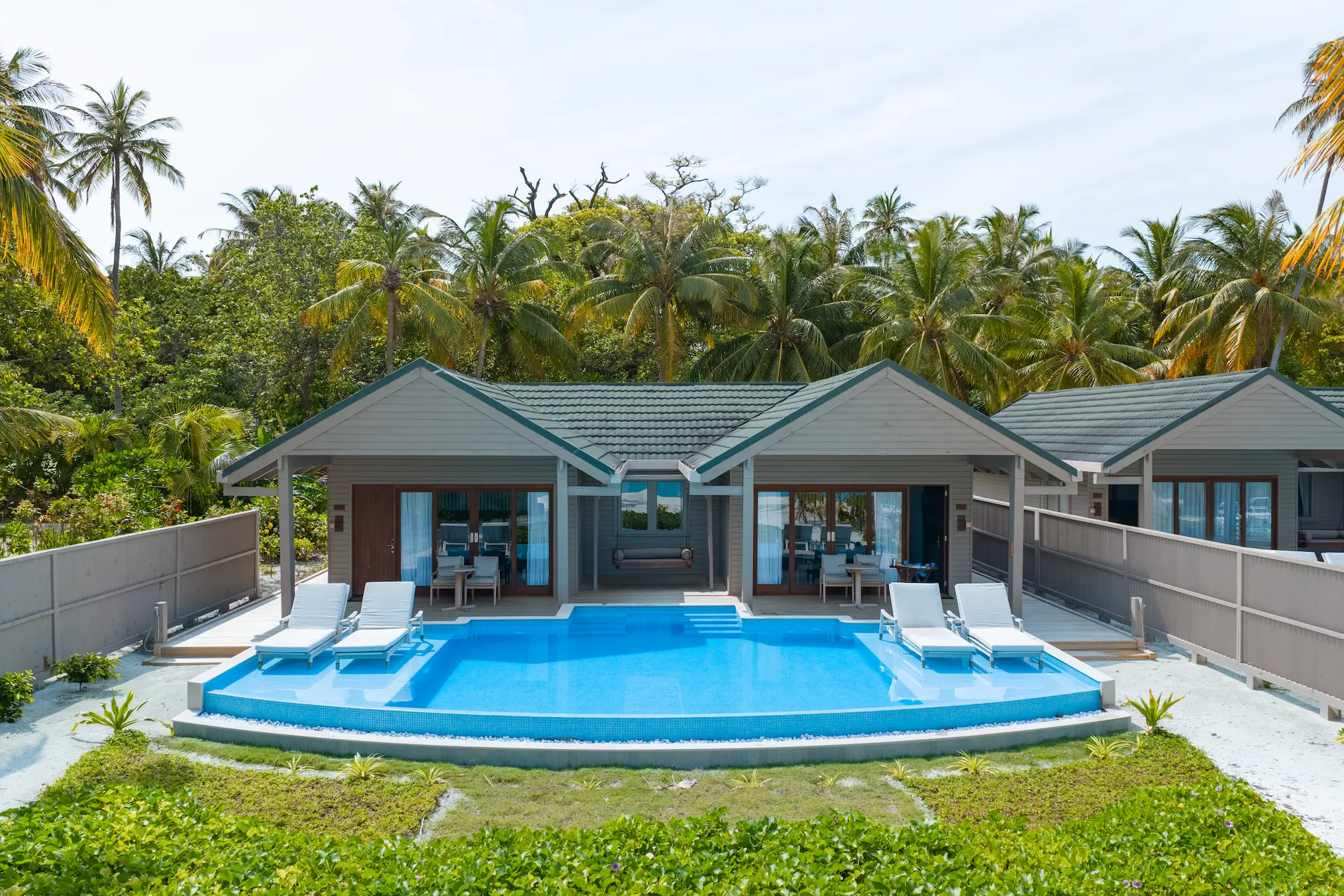 meeru maldives two bedroom beach pool villa aerial view showcasing private pool, direct beach access and lush tropical surroundings in a serene island setting