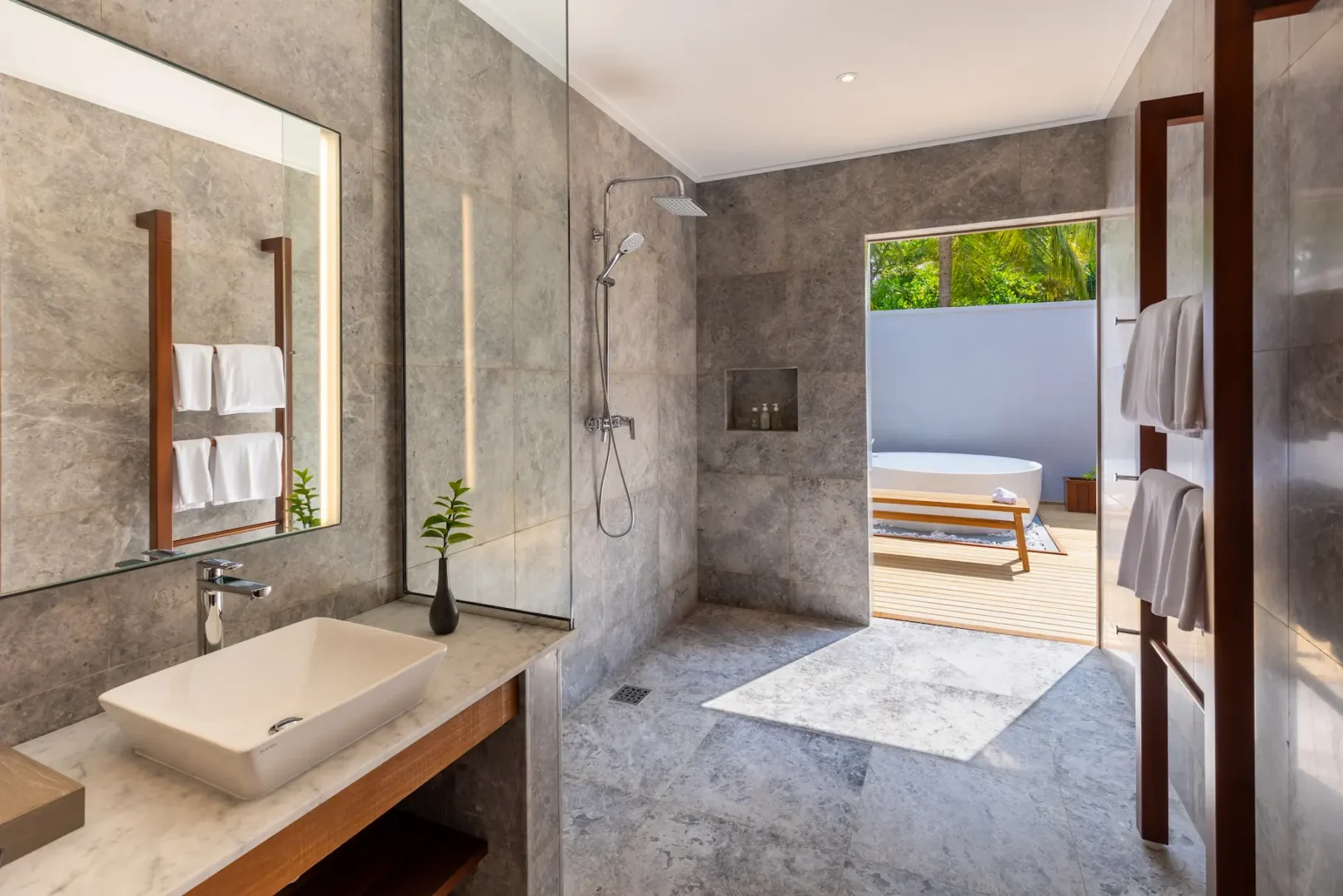 meeru maldives two bedroom beach pool villa bathroom sink with elegant finishes, double vanity design and a tranquil open air tropical setting