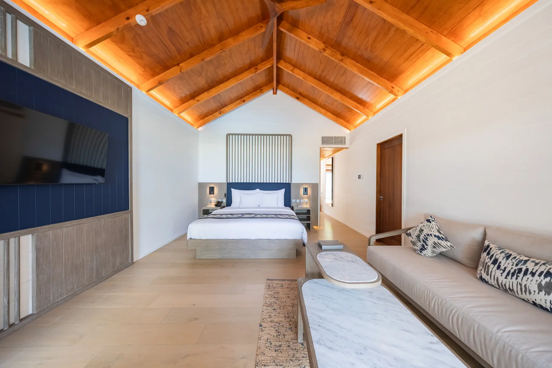 meeru maldives two bedroom beach pool villa interior second bedroom featuring elegant design, natural textures and a tranquil tropical setting surrounded by lush greenery