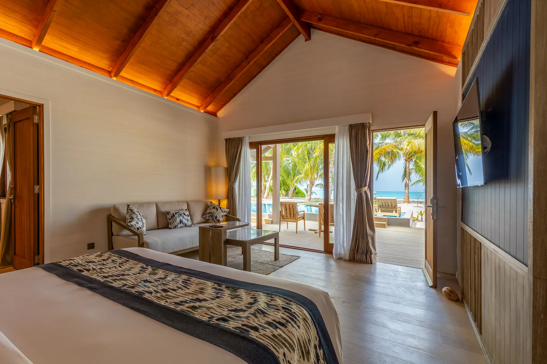 meeru maldives two bedroom beach pool villa master bedroom featuring spacious layout, elegant design and serene tropical surroundings in a tranquil island setting