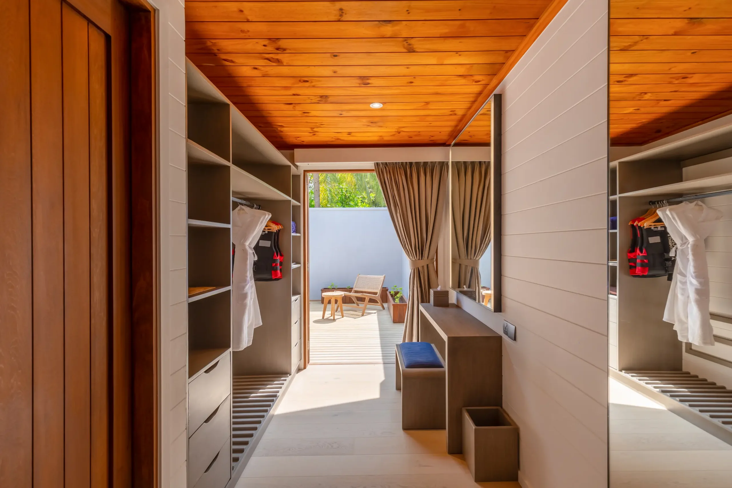 meeru maldives two bedroom beach pool villa wardrobe area featuring spacious storage, elegant finishes and a refined tropical interior setting