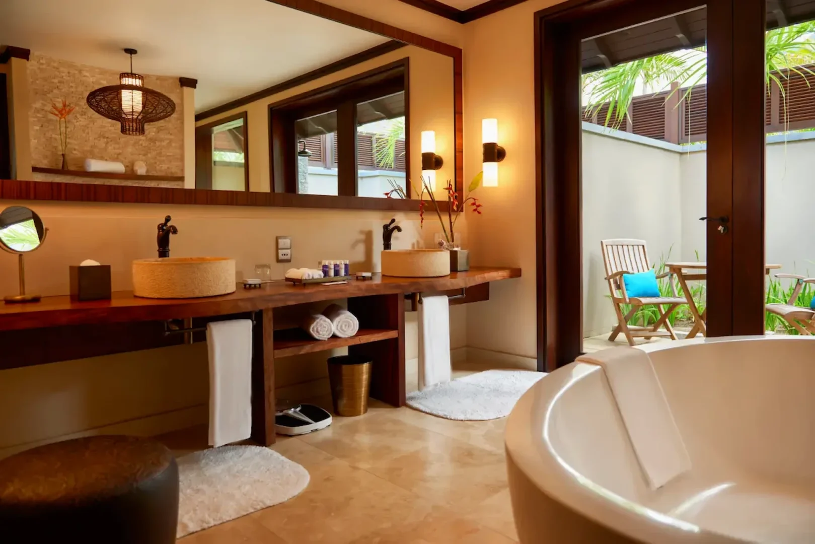 tropical bathroom sink with greenery and wood accents