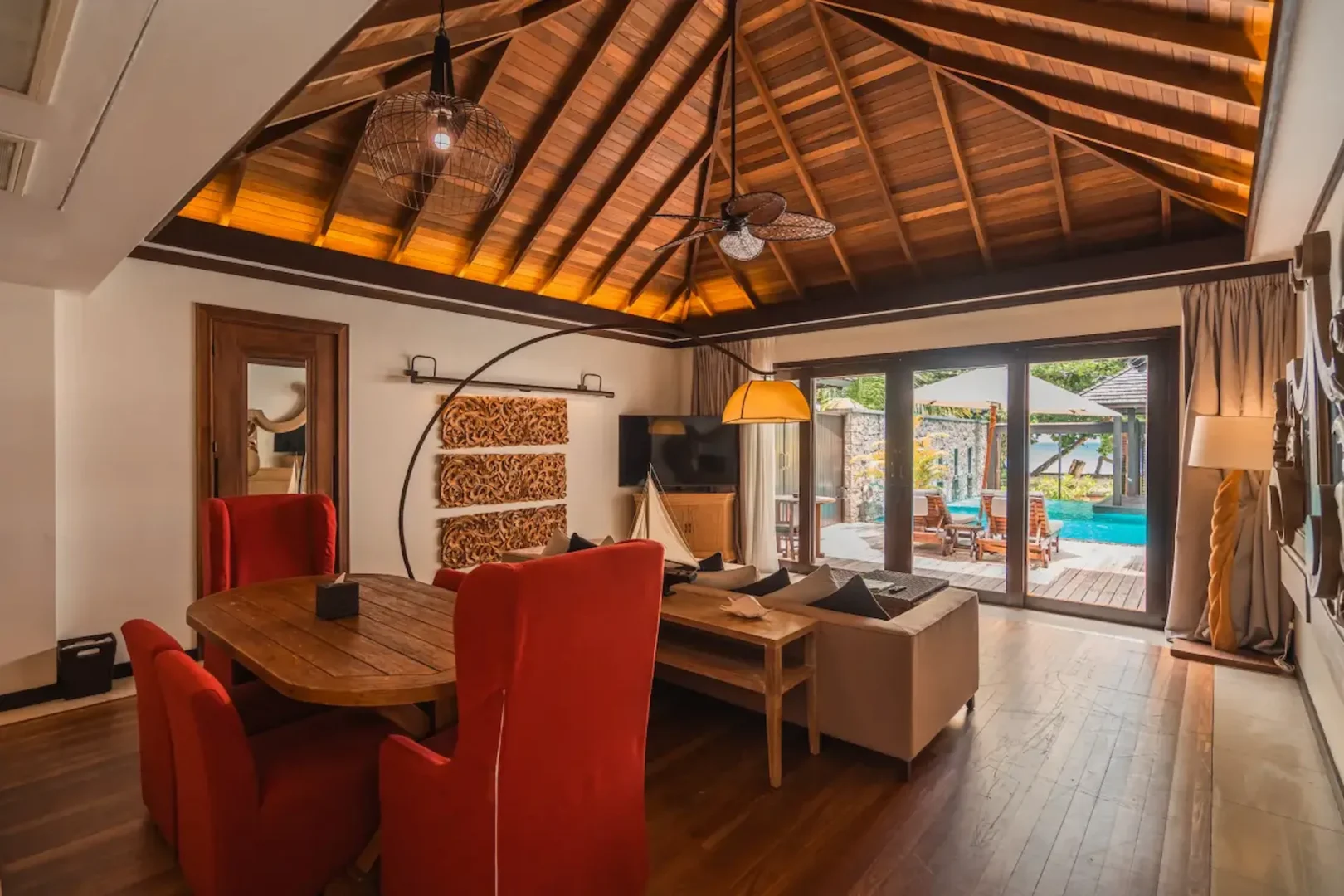 eychelles dining area with ocean view and natural wood table