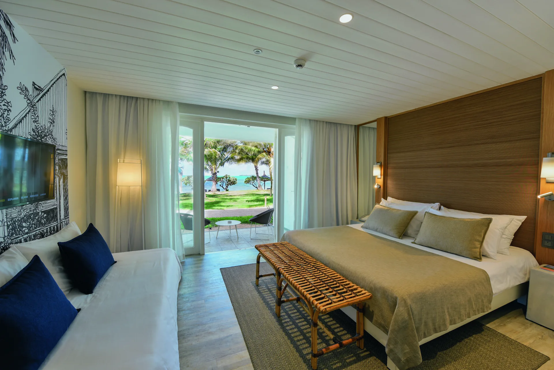 superior sea facing room with bed sofa and ocean view at cannonier mauritius
