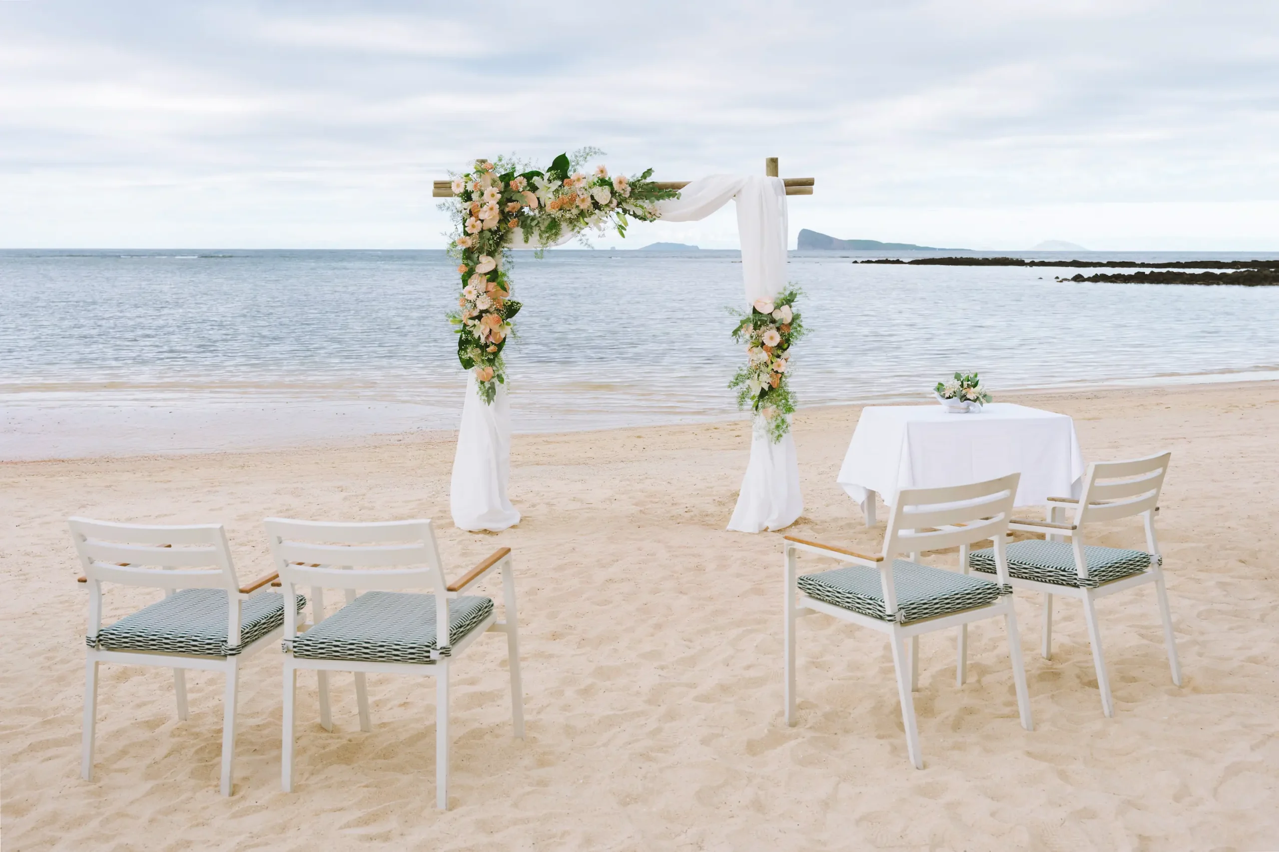 cannonier beachcomber golf resort spa mauritius wedding beach setup featuring elegant ceremony seating tropical floral arrangements romantic ocean views and a luxury beachfront setting for an unforgettable island celebration