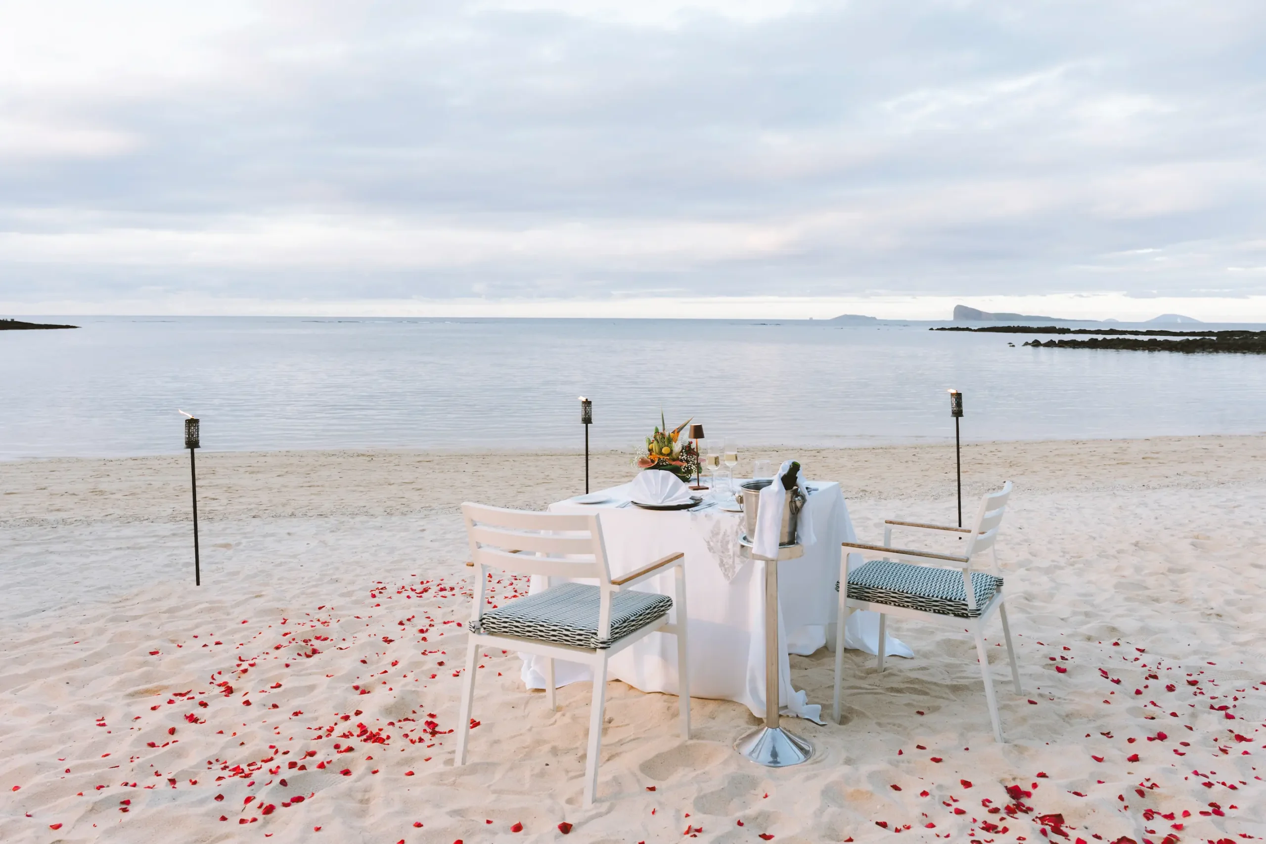 cannonier beachcomber golf resort spa mauritius wedding dinner setup with elegantly arranged dining tables romantic candlelit décor tropical floral accents and a luxury beachfront celebration atmosphere