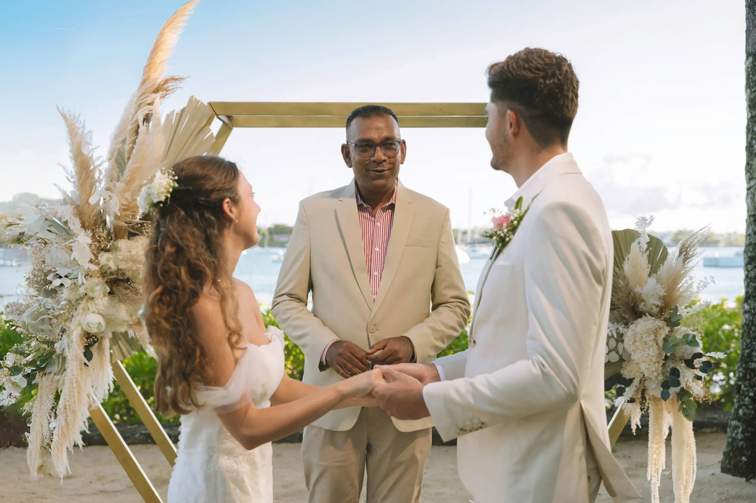 mauricia beachcomber resort spa mauritius wedding beach ceremony featuring a couple exchanging vows by the ocean surrounded by tropical scenery elegant floral decorations and a romantic luxury beachfront setting