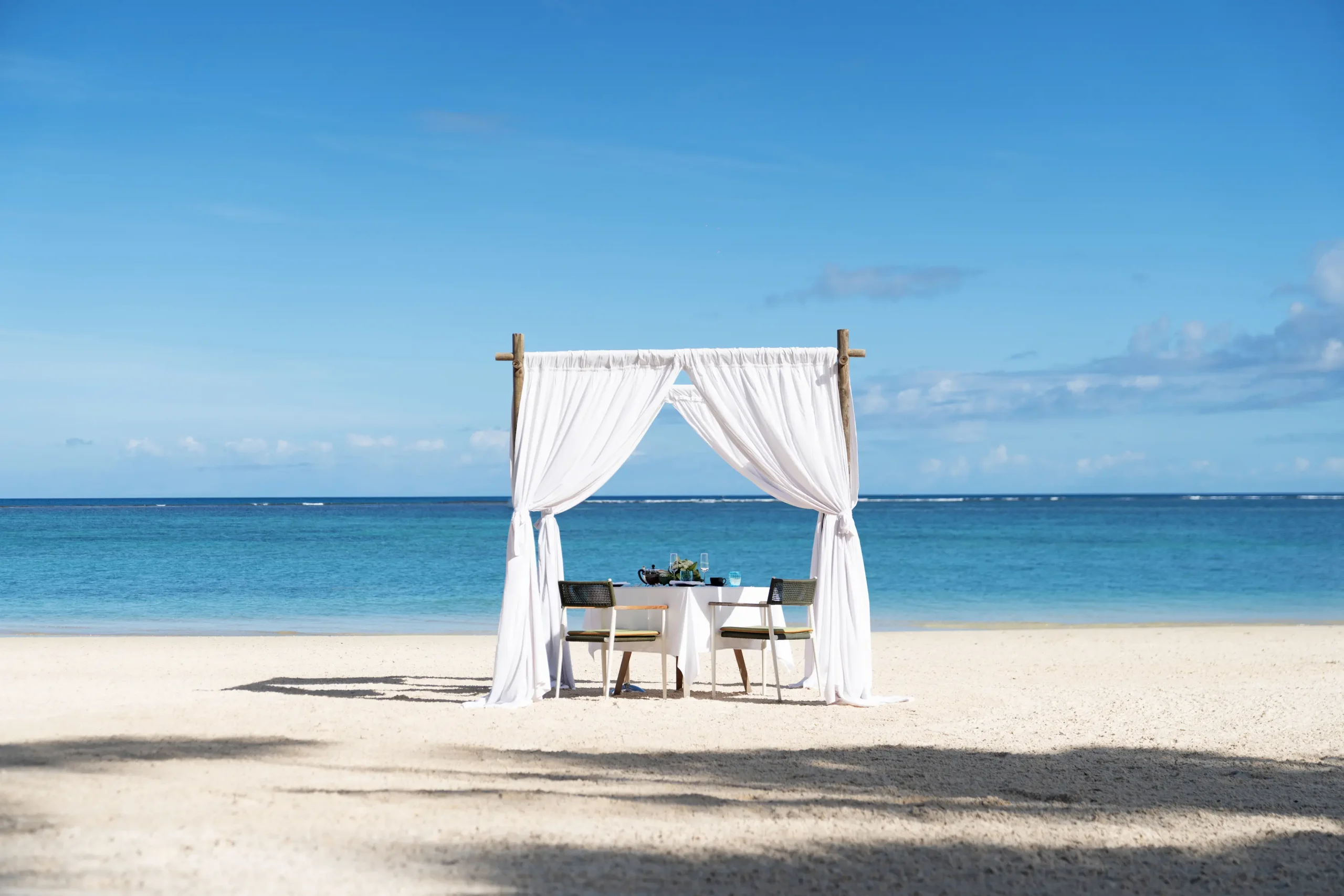 trou aux biches beachcomber golf resort spa mauritius wedding dinner setup with elegantly arranged tables candlelit ambiance refined décor and luxury dining arrangements for a romantic celebration