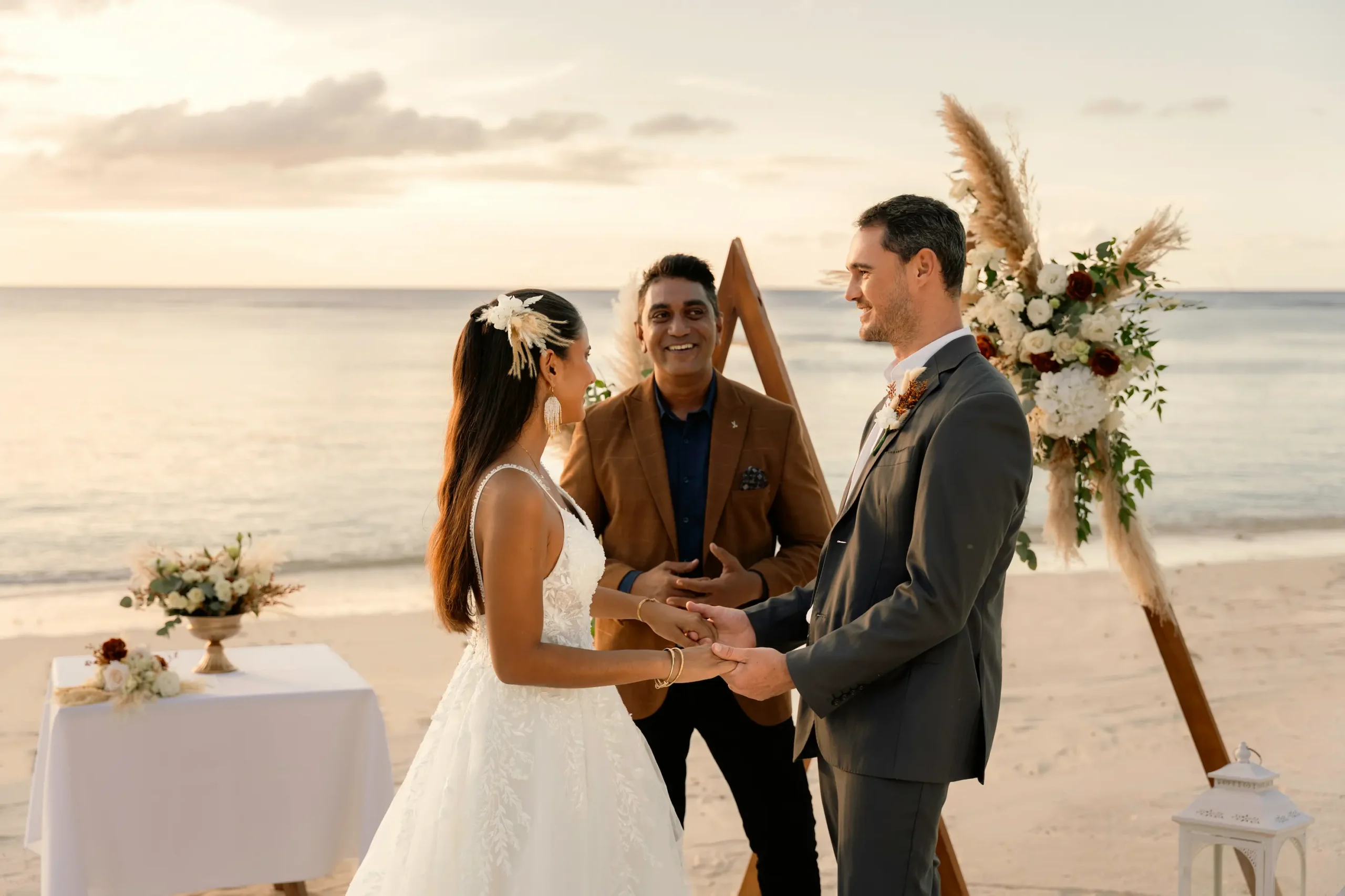 victoria beachcomber resort spa mauritius wedding beach ceremony with a couple exchanging vows beside the ocean surrounded by elegant tropical décor and a romantic luxury beachfront setting