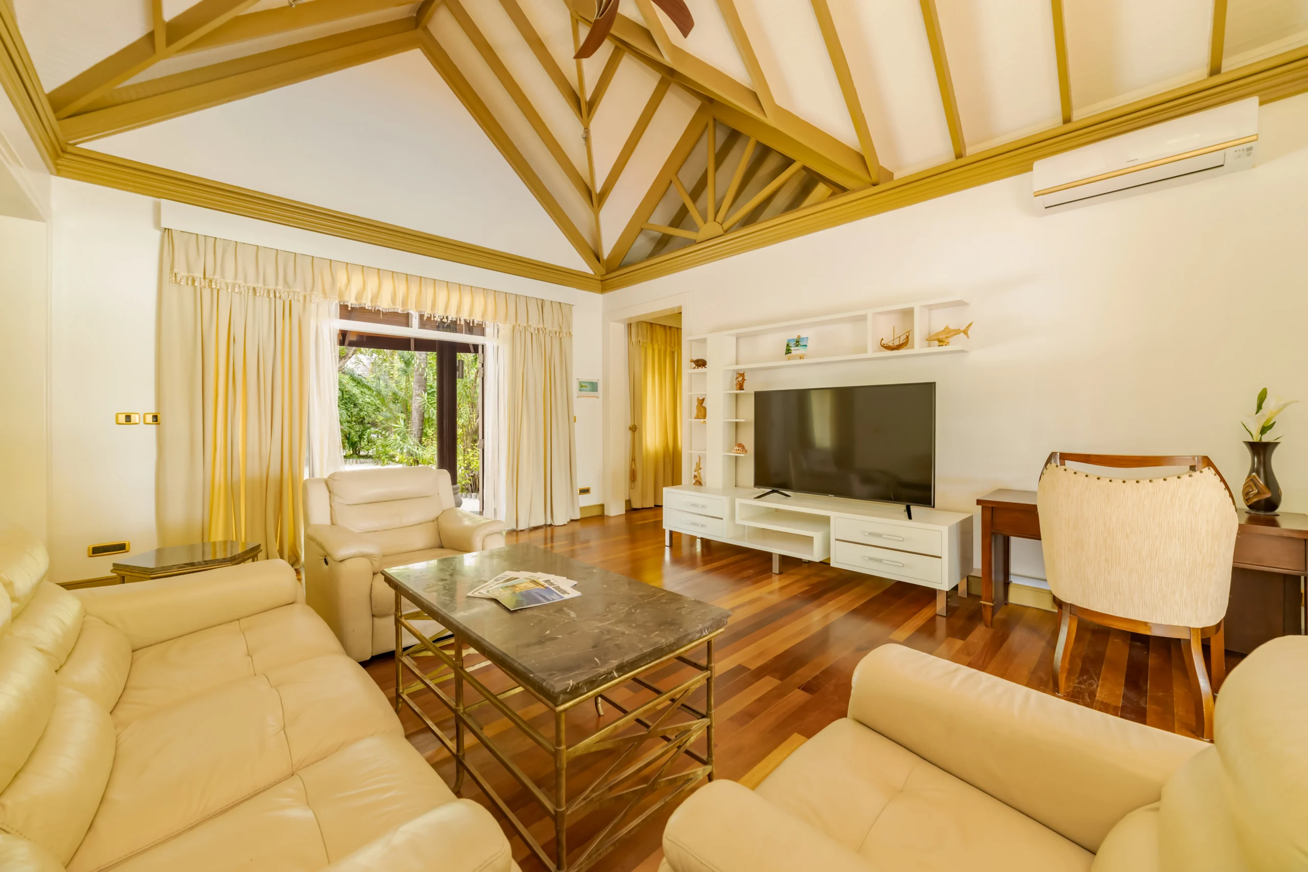 living area in a two bedroom beach suite at sun siyam olhuveli maldives featuring spacious accommodation and contemporary furnishings