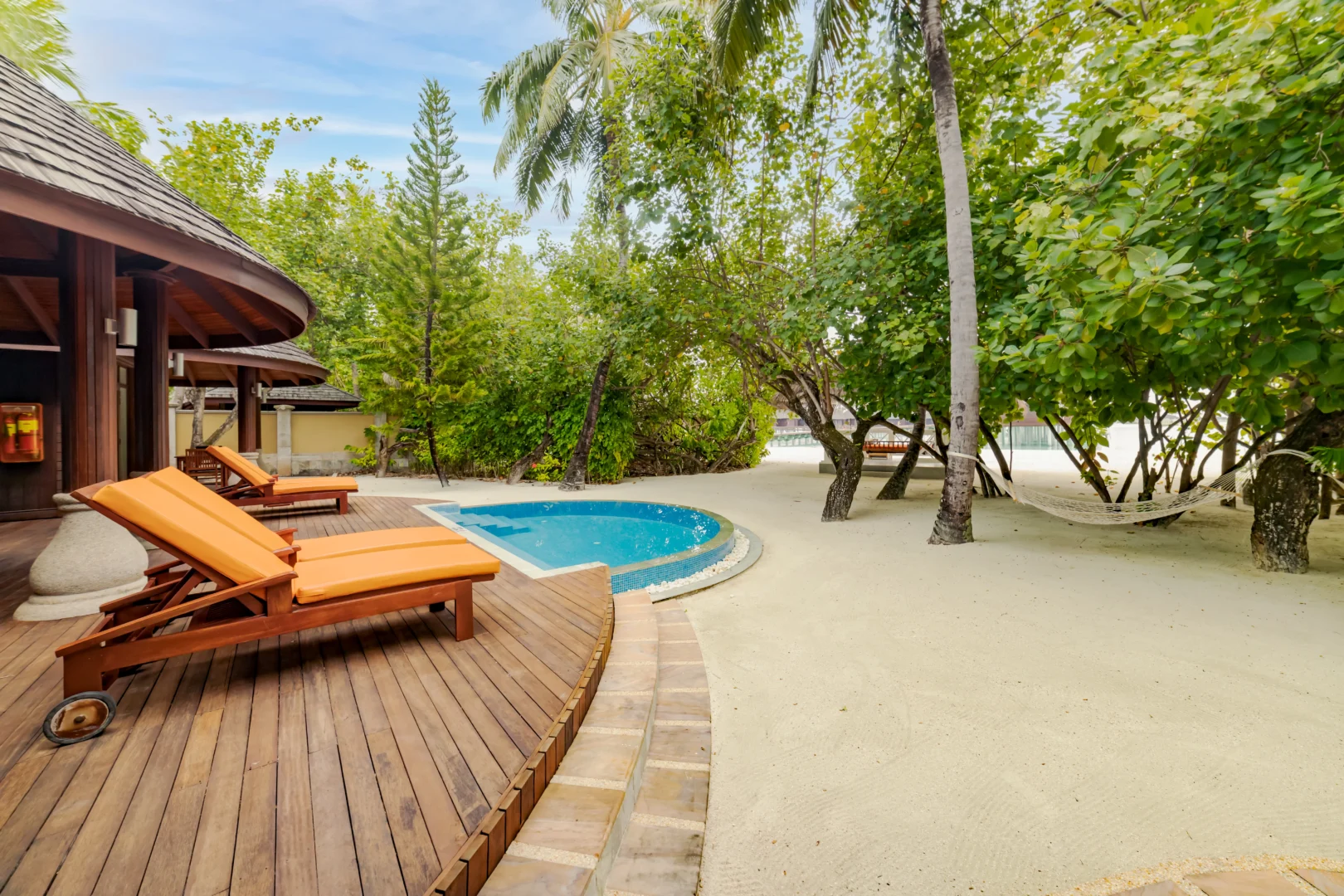 sun loungers outside a two bedroom beach suite at sun siyam olhuveli maldives providing space for outdoor relaxation