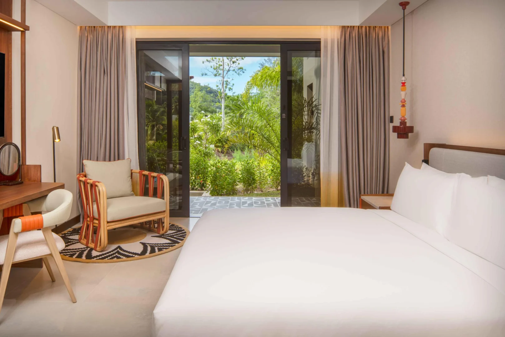 King bedroom in the Two Bedroom Apartment with Nature View at Canopy by Hilton Seychelles Resort in Mahé, Seychelles, featuring a king-size bed and contemporary island-inspired décor.