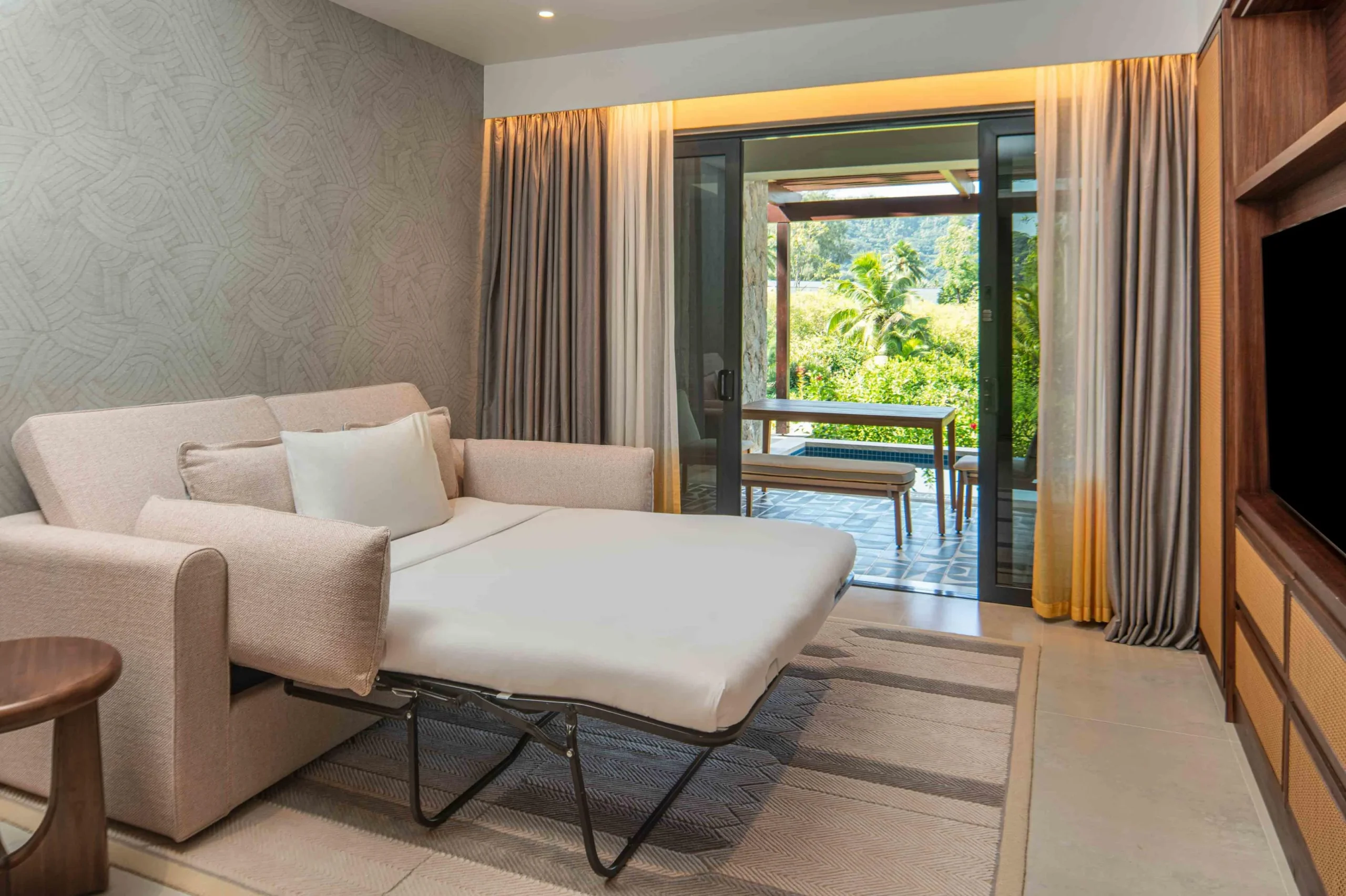 Sofa bed in the King One Bedroom Apartment with Private Pool at Canopy by Hilton Seychelles Resort in Mahé, Seychelles, providing additional sleeping space within the apartment-style accommodation.