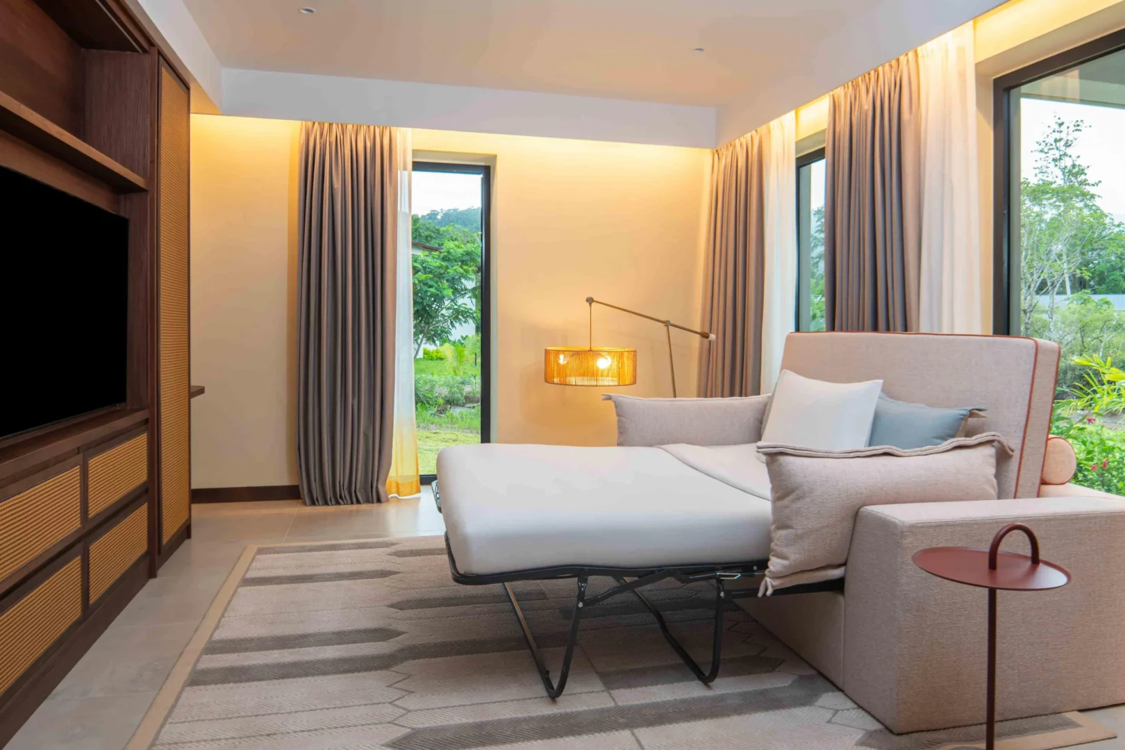 Sofa bed in the Two Bedroom Apartment with Nature View at Canopy by Hilton Seychelles Resort in Mahé, Seychelles, providing additional sleeping space within the apartment-style accommodation.