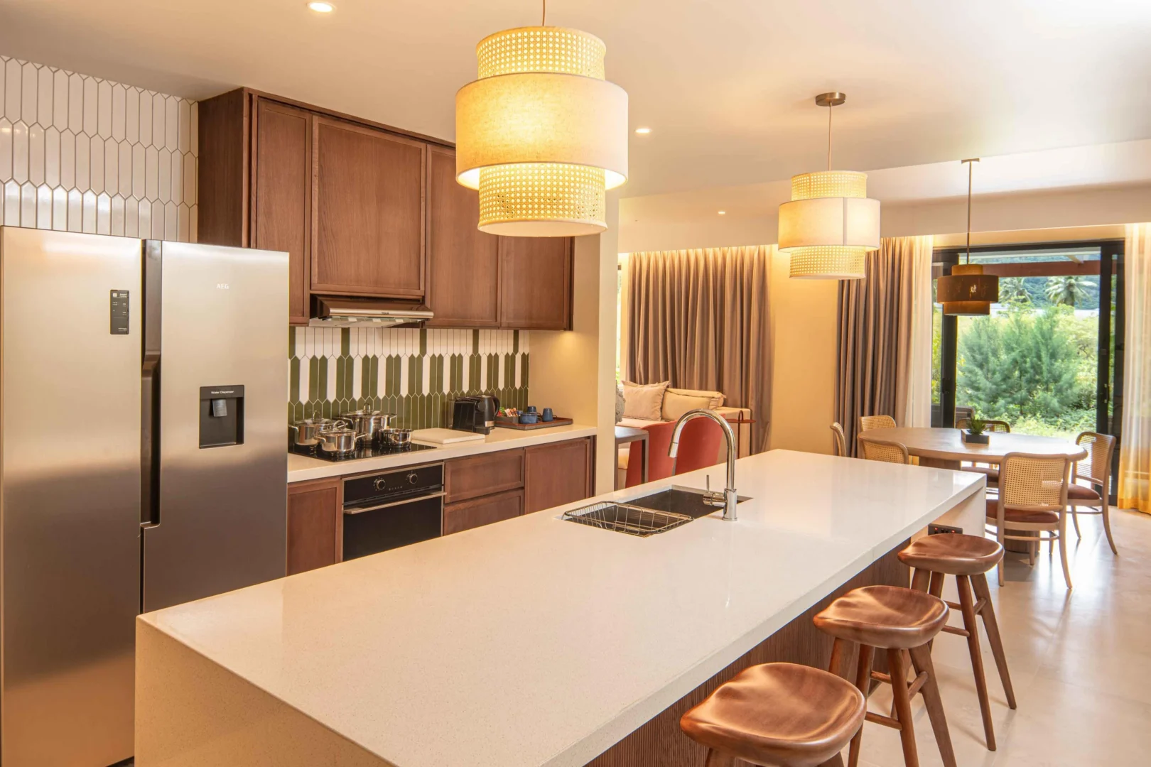 Kitchen in the Two Bedroom Apartment with Nature View at Canopy by Hilton Seychelles Resort in Mahé, Seychelles, featuring contemporary design and integrated living and dining space.