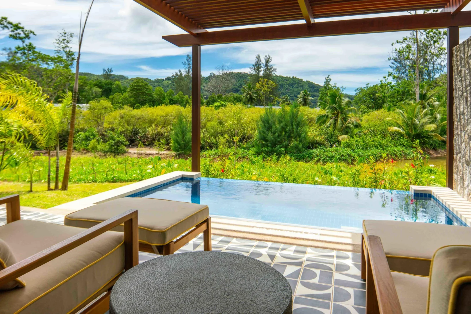 Terrace of the Two Bedroom Apartment with Private Pool at Canopy by Hilton Seychelles Resort in Mahé, Seychelles, featuring outdoor living space and direct access to a private pool.