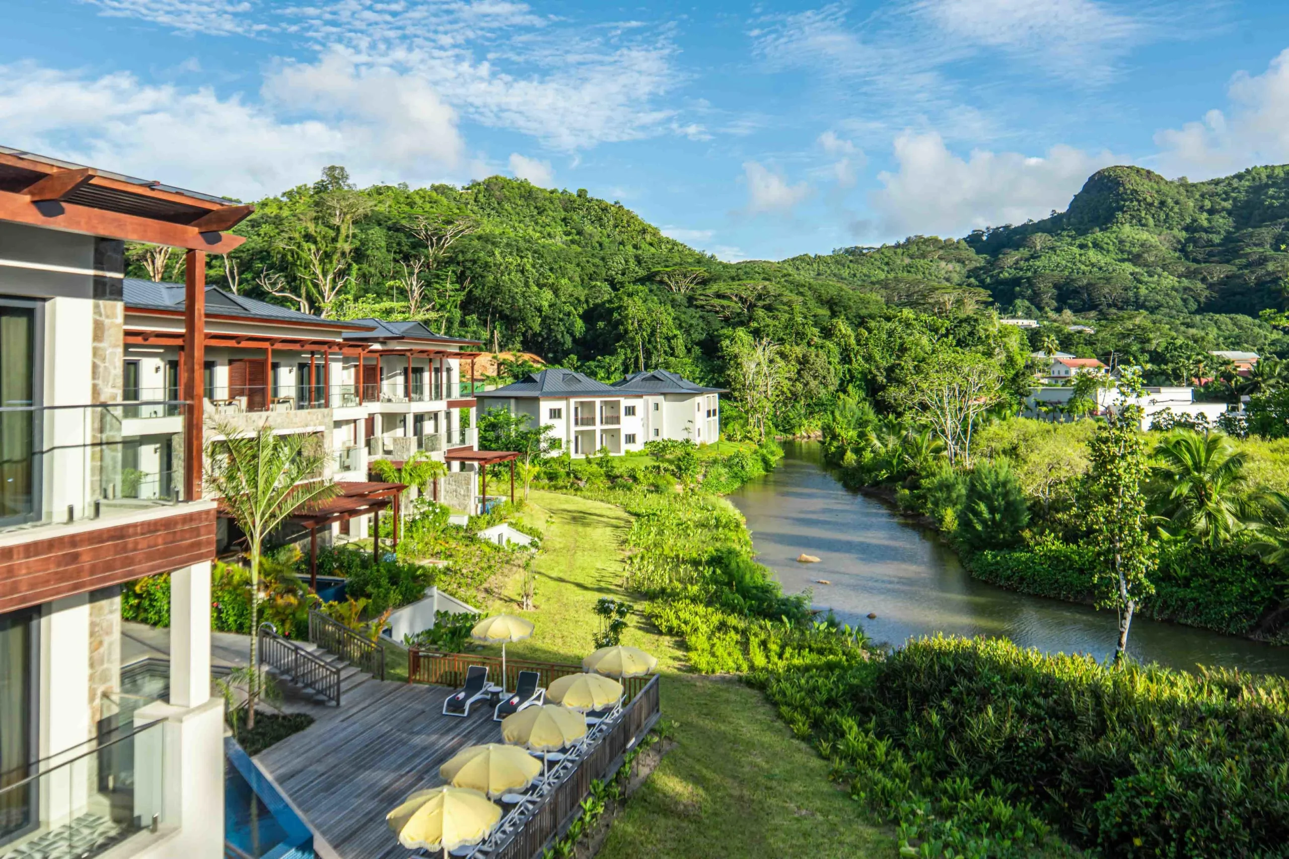 Gardens surrounding the resort apartments at Canopy by Hilton Seychelles Resort in Mahé, Seychelles, featuring landscaped greenery and outdoor spaces within the resort grounds.