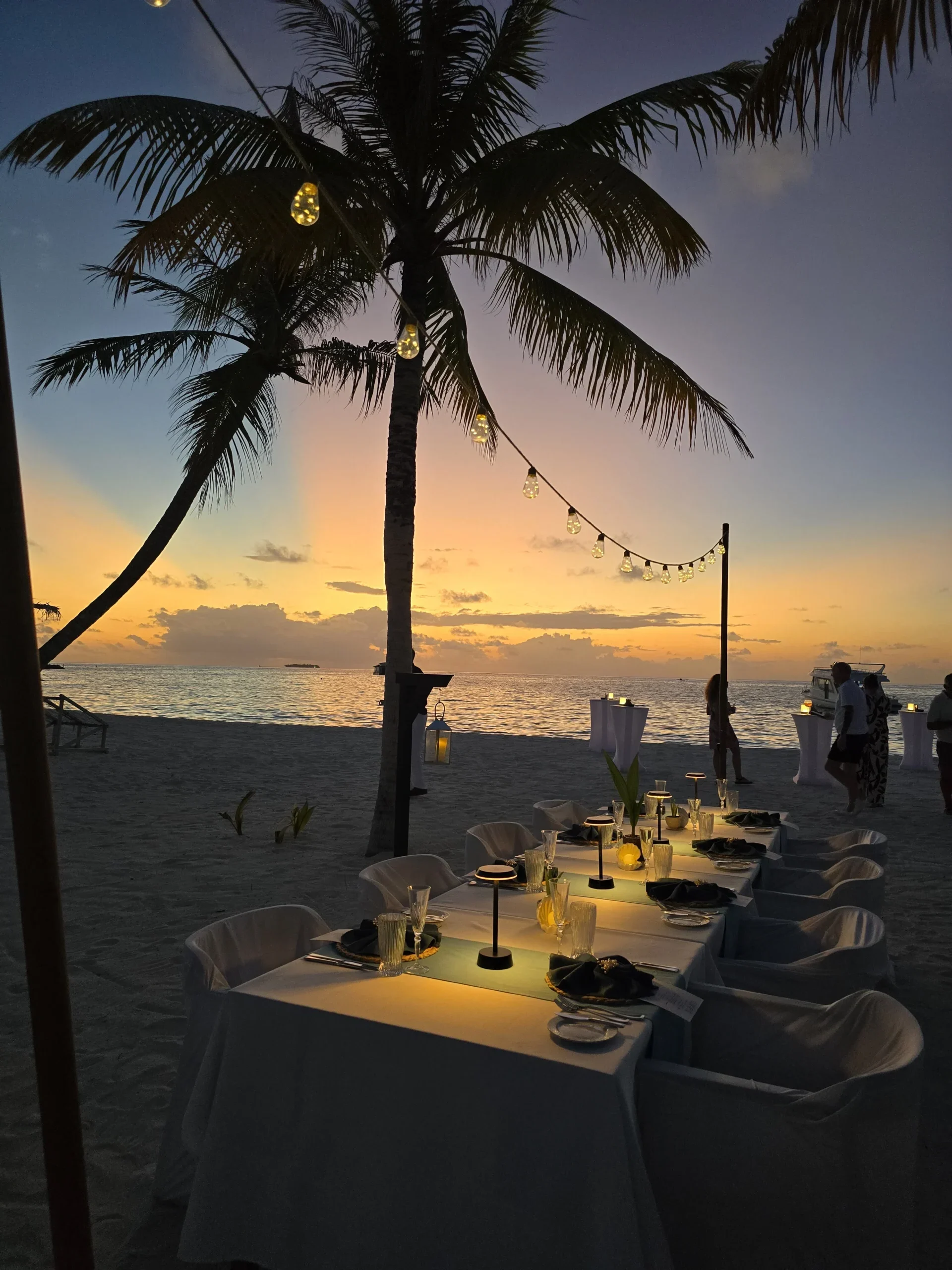 James and Natasha Oliphant from Not Just Travel enjoying a sunset dinner experience, showcasing memorable holiday moments and personalised travel experiences.