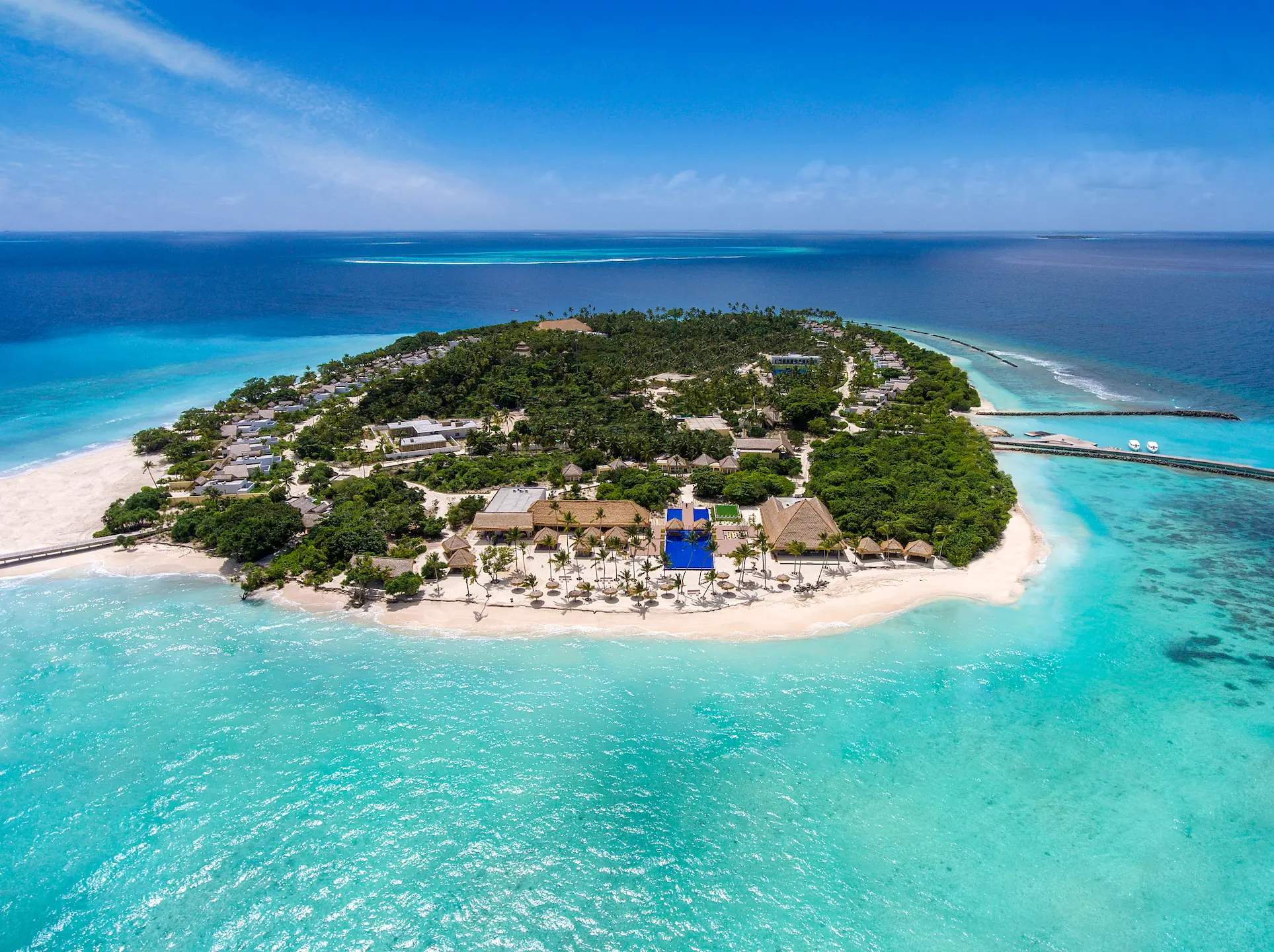 overview of emerald maldives resort & spa in the maldives showcasing the private island, overwater villas, white sand beaches, tropical greenery and surrounding lagoon