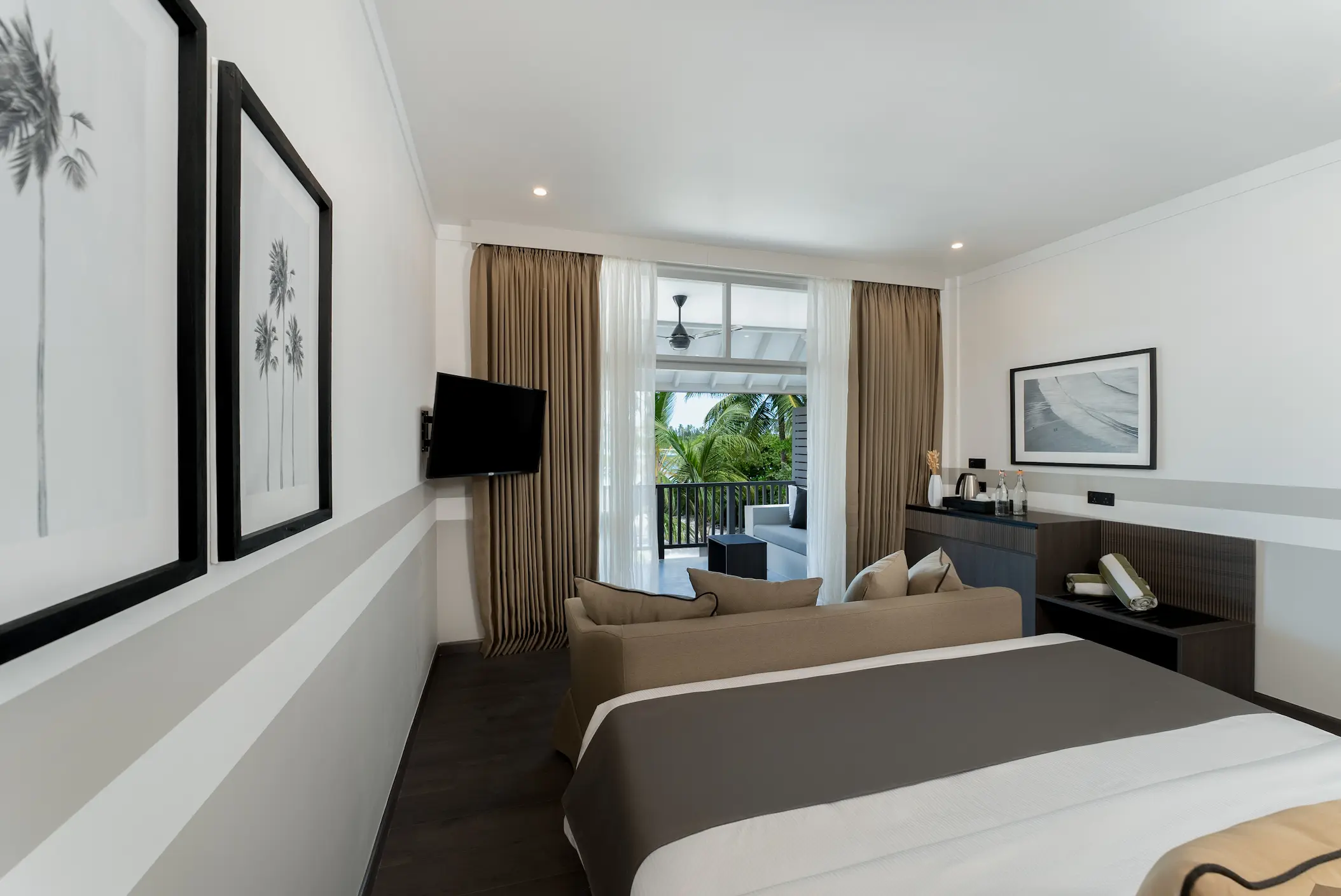 king size bed in a beach pavilion at sun siyam olhuveli maldives featuring contemporary furnishings and beachside accommodation