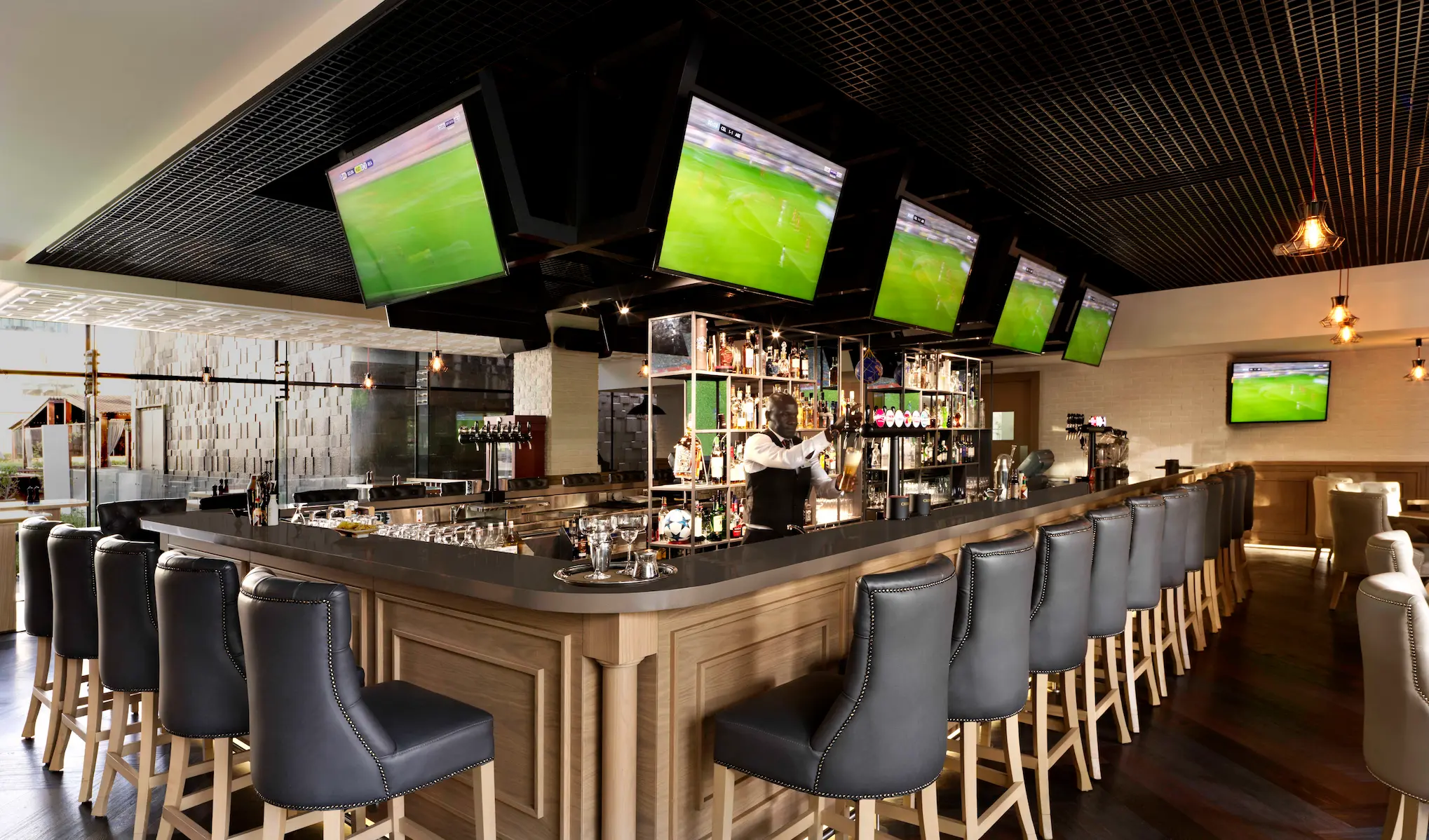 Bridges Bar at Fairmont Bab Al Bahr Abu Dhabi serving drinks and light bites in a contemporary lounge setting