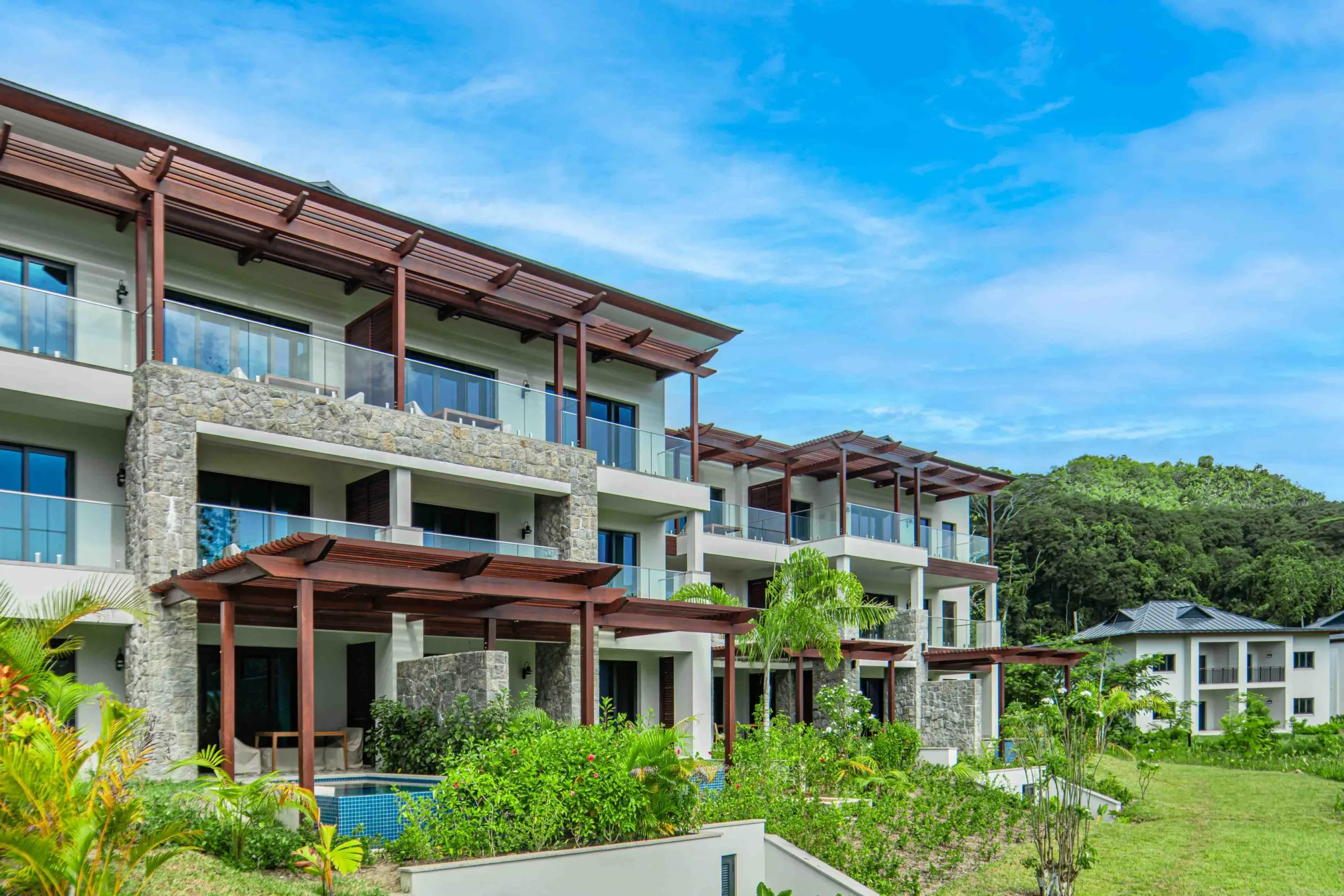Exterior of the Canopy Apartments at Canopy by Hilton Seychelles Resort in Mahé, Seychelles, showcasing the apartment-style accommodation within the resort grounds.