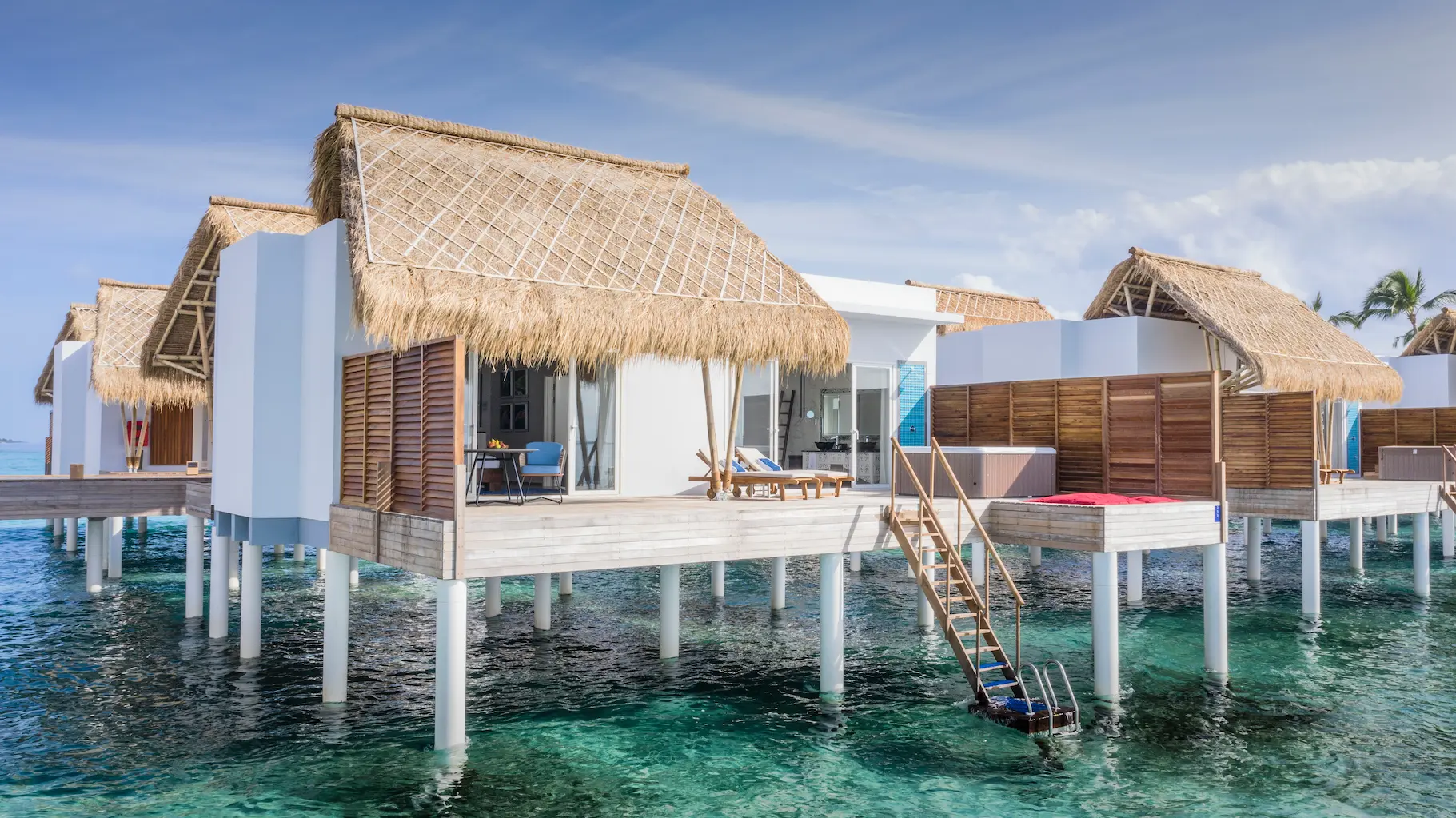 exterior of a jacuzzi water villa at emerald maldives resort & spa in the maldives set above the lagoon with a private outdoor jacuzzi, sundeck and direct ocean access