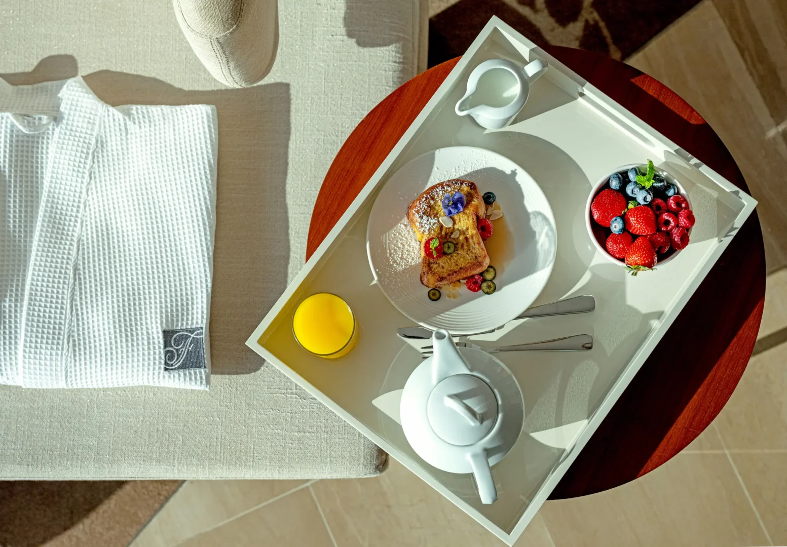 Deluxe Room breakfast setup at Fairmont Bab Al Bahr Abu Dhabi featuring in-room dining and contemporary luxury accommodation