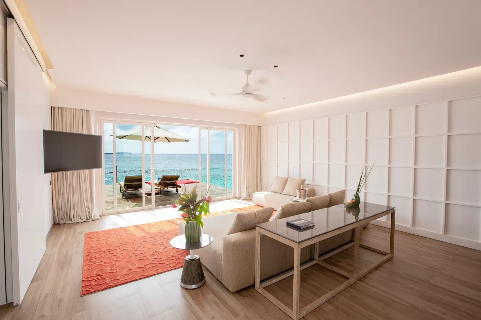 living area in a superior water villa with pool at emerald maldives resort & spa in the maldives featuring contemporary furnishings, spacious interiors and direct access to the private overwater terrace and pool