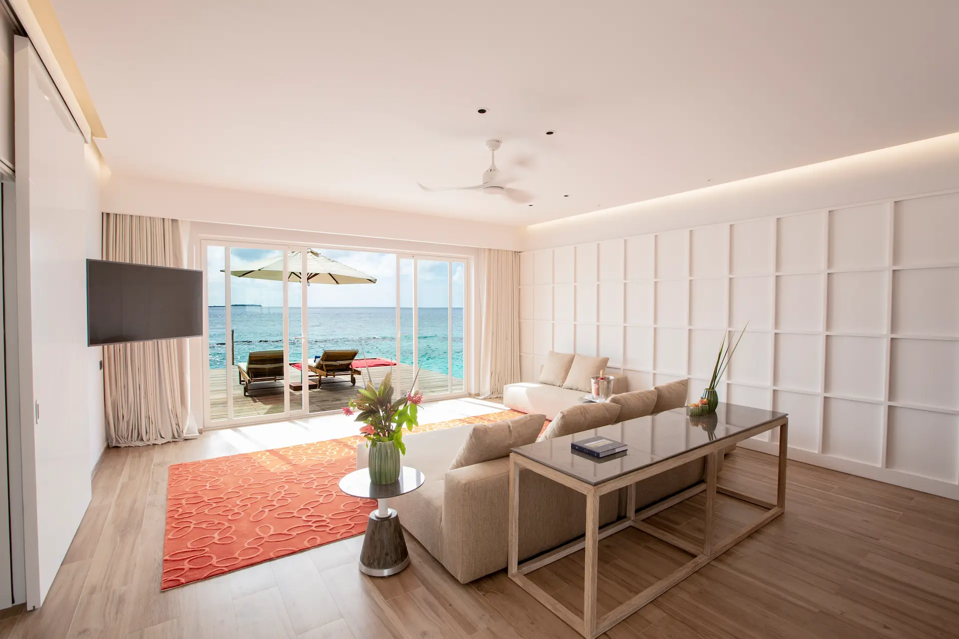 living area in a superior water villa with pool at emerald maldives resort & spa in the maldives featuring contemporary furnishings, spacious interiors and direct access to the private overwater terrace and pool