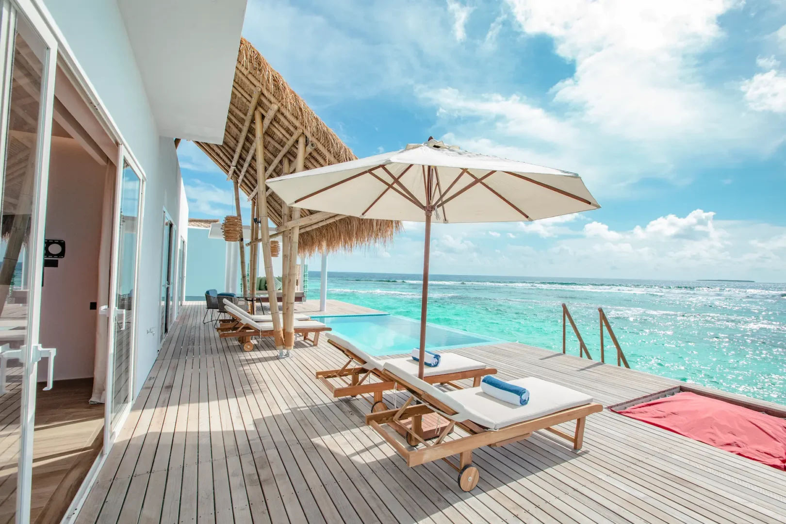 terrace of a superior water villa with pool at emerald maldives resort & spa in the maldives featuring a private pool, outdoor seating and panoramic lagoon views