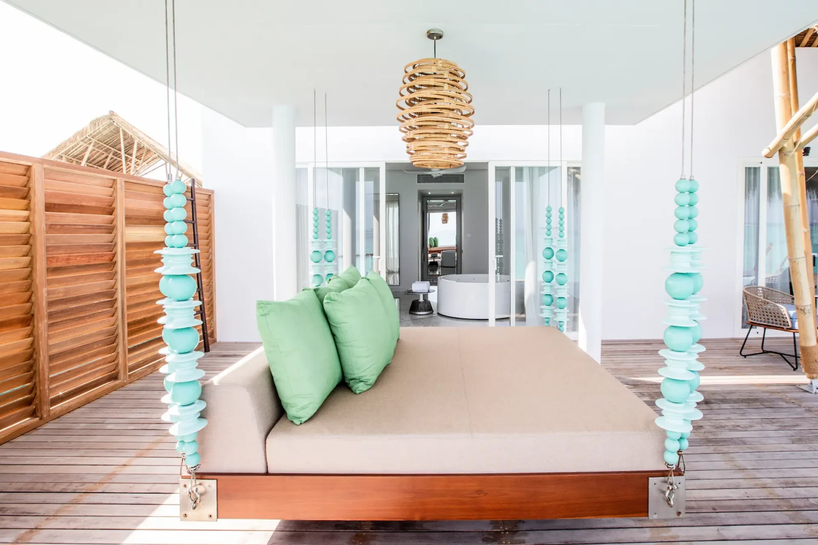 day bed on the outdoor terrace of a superior water villa with pool at emerald maldives resort & spa in the maldives overlooking the private pool and lagoon views