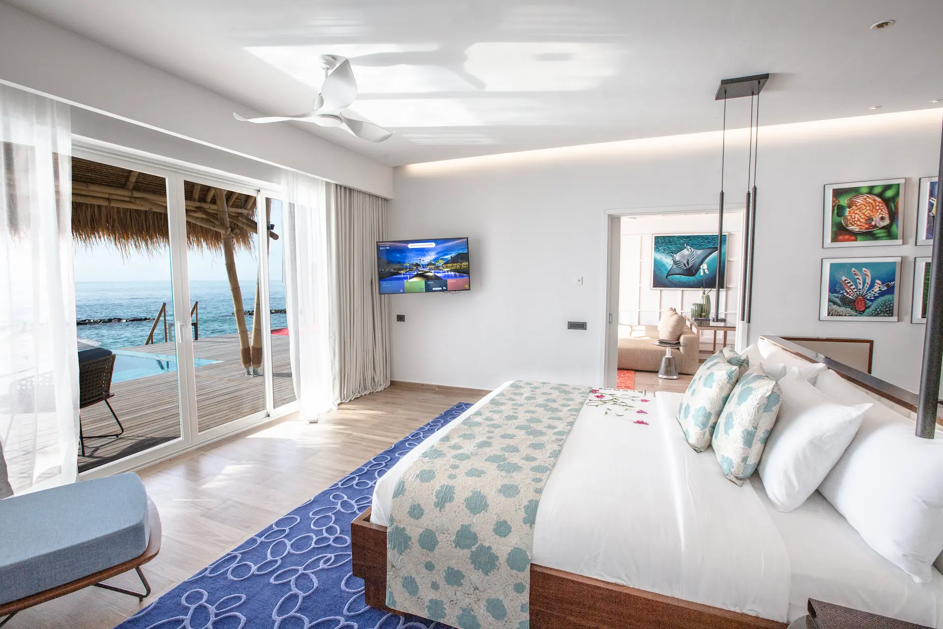 bedroom in a superior water villa with pool at emerald maldives resort & spa in the maldives featuring contemporary interiors and direct access to a private overwater terrace, pool and lagoon views