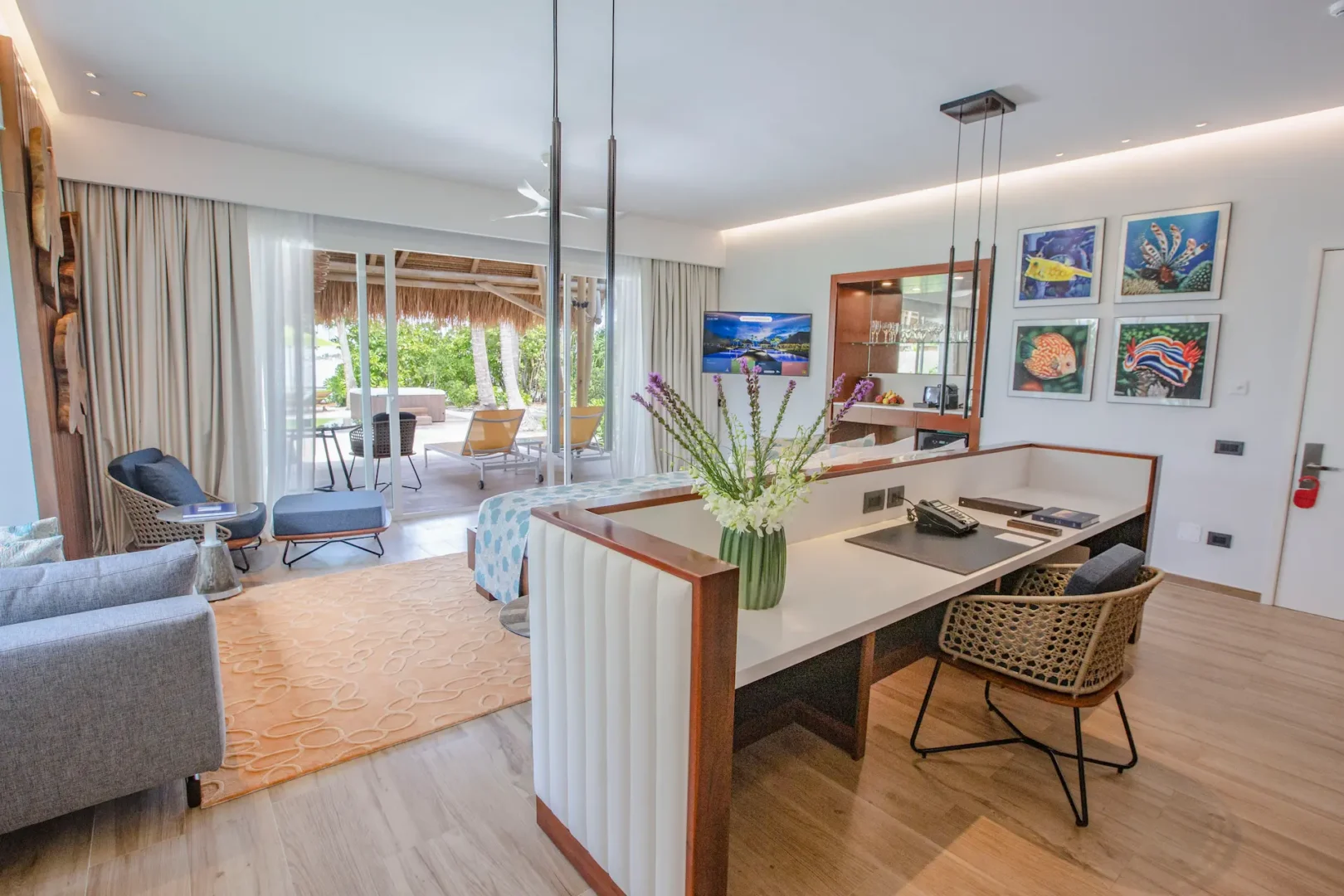 interior of a jacuzzi beach villa at emerald maldives resort & spa in the maldives featuring contemporary furnishings, spacious living areas and direct access to the outdoor terrace