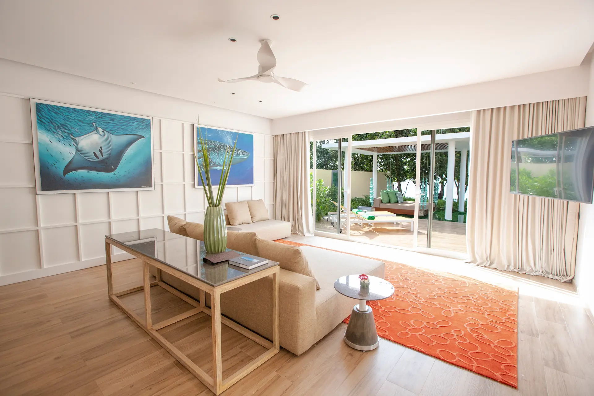 living area in a superior beach villa with pool at emerald maldives resort & spa in the maldives featuring contemporary furnishings, spacious interiors and direct access to the outdoor terrace