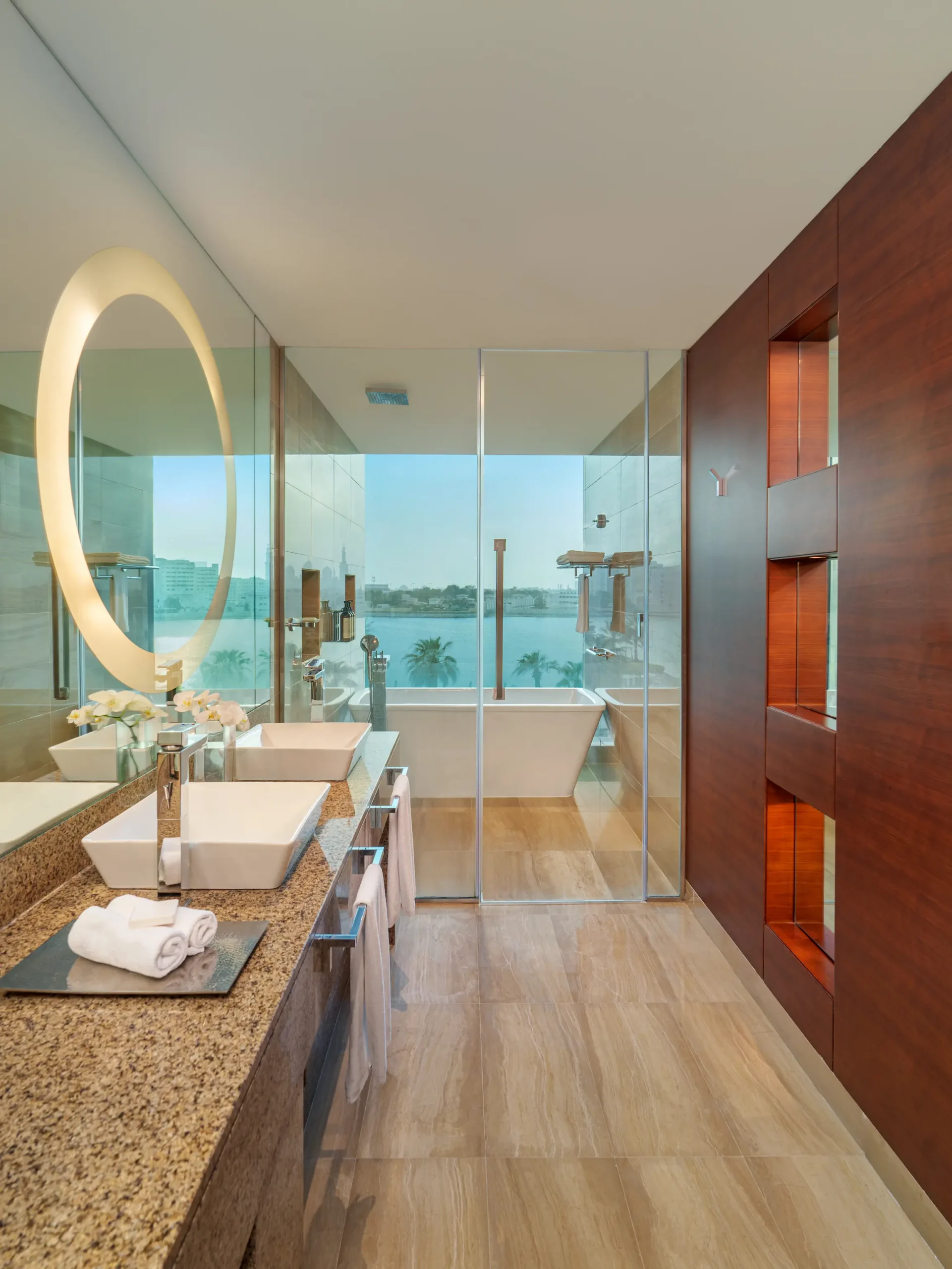 Deluxe Room bathroom at Fairmont Bab Al Bahr Abu Dhabi featuring a spacious layout, walk-in shower, bathtub and luxury amenities