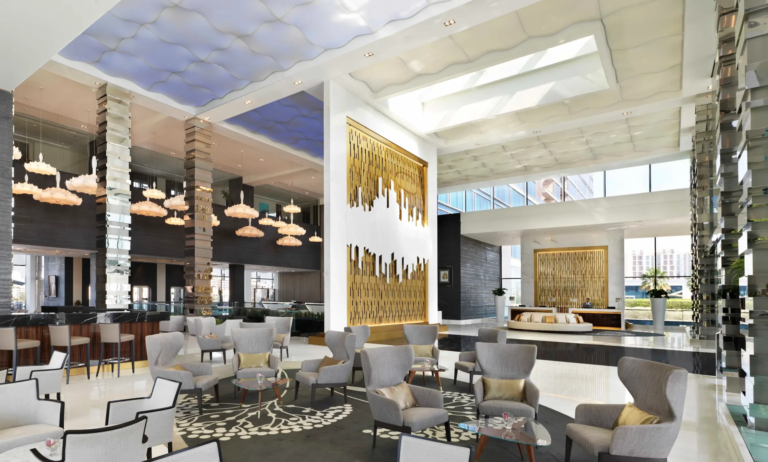 Lobby at Fairmont Bab Al Bahr Abu Dhabi featuring contemporary design, spacious seating areas and views towards the Sheikh Zayed Grand Mosque