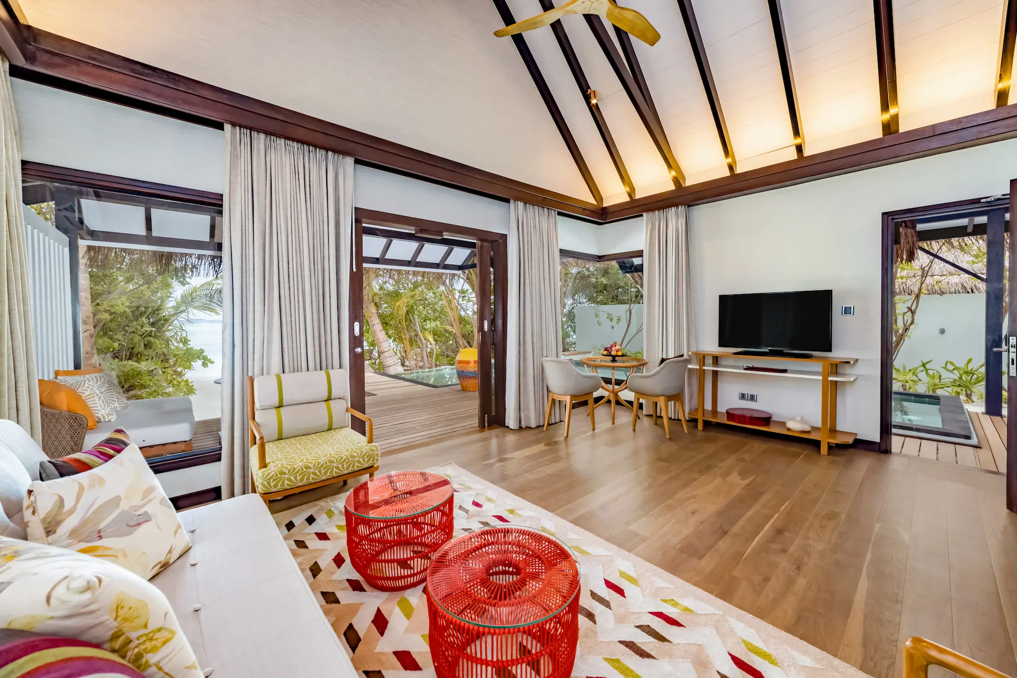 Contemporary living room interior in an Earth Pool Pavilion at OZEN LIFE MAADHOO, featuring spacious lounge areas and family-friendly accommodation with separate indoor living space