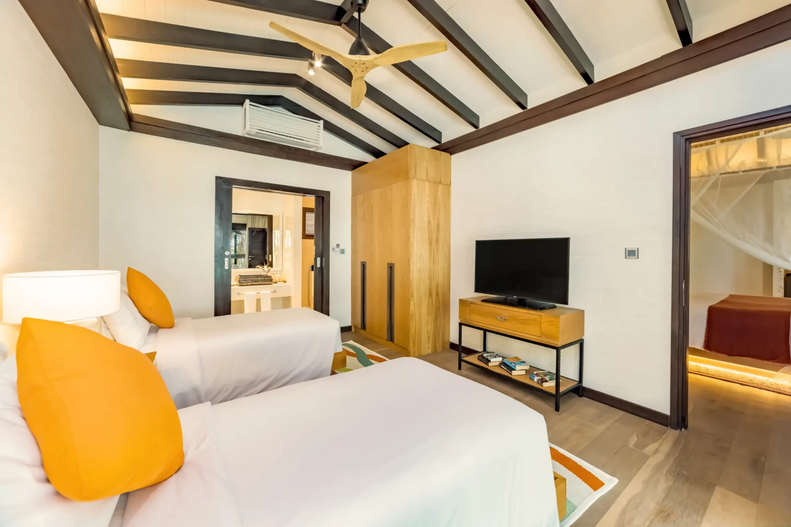 Twin bedroom in an Earth Pool Pavilion at OZEN LIFE MAADHOO, featuring contemporary furnishings, spacious accommodation and a layout designed for families or groups