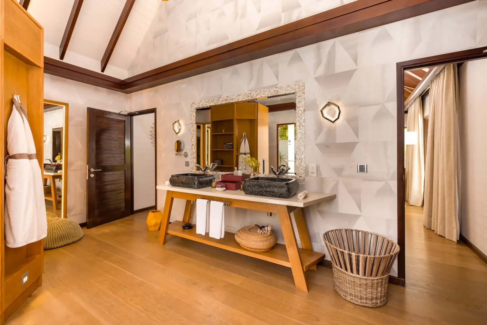 Spacious bathroom in an Earth Villa at OZEN LIFE MAADHOO featuring a handcrafted bathtub, monsoon shower and indoor-outdoor design