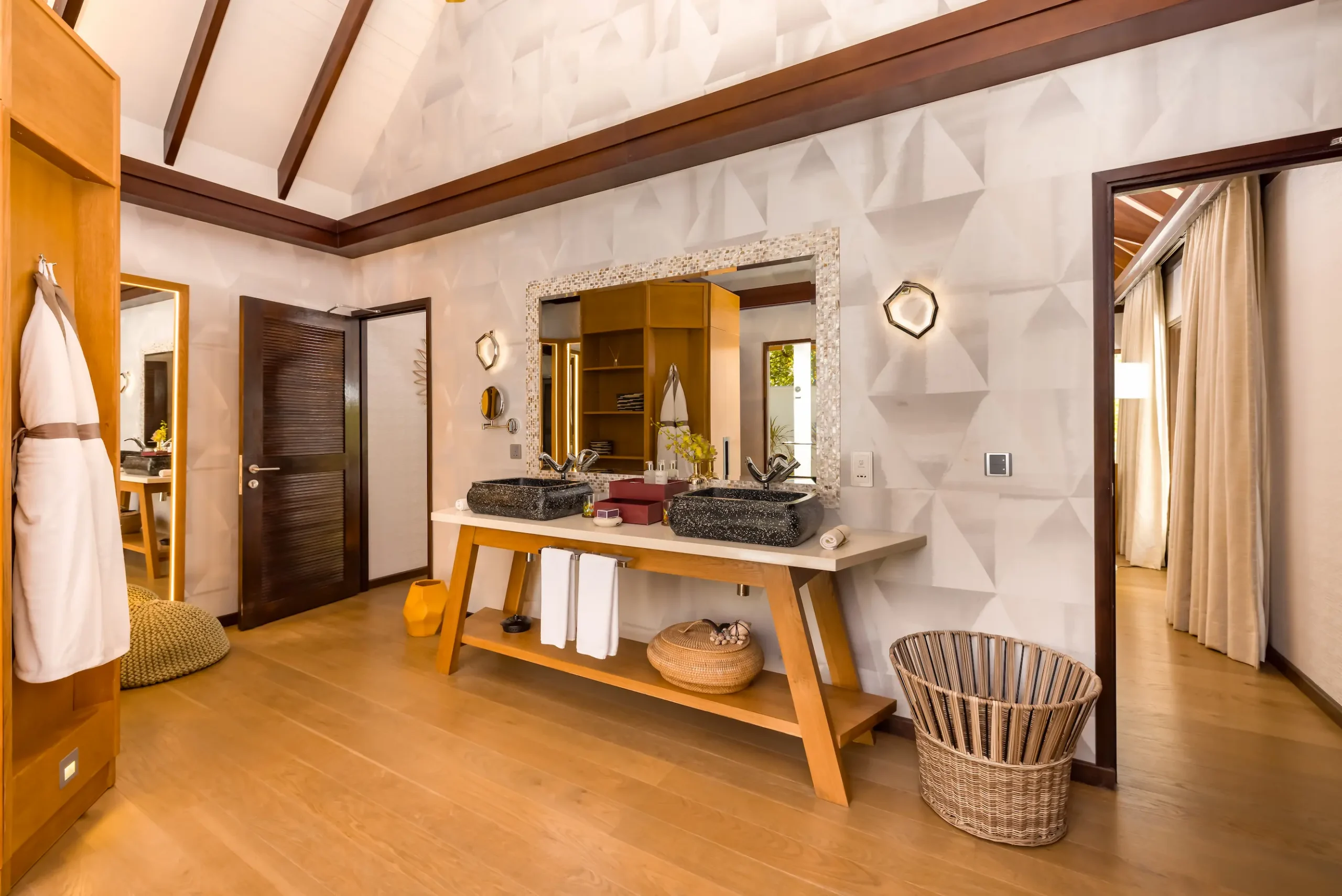 Spacious bathroom in an Earth Villa at OZEN LIFE MAADHOO featuring a handcrafted bathtub, monsoon shower and indoor-outdoor design