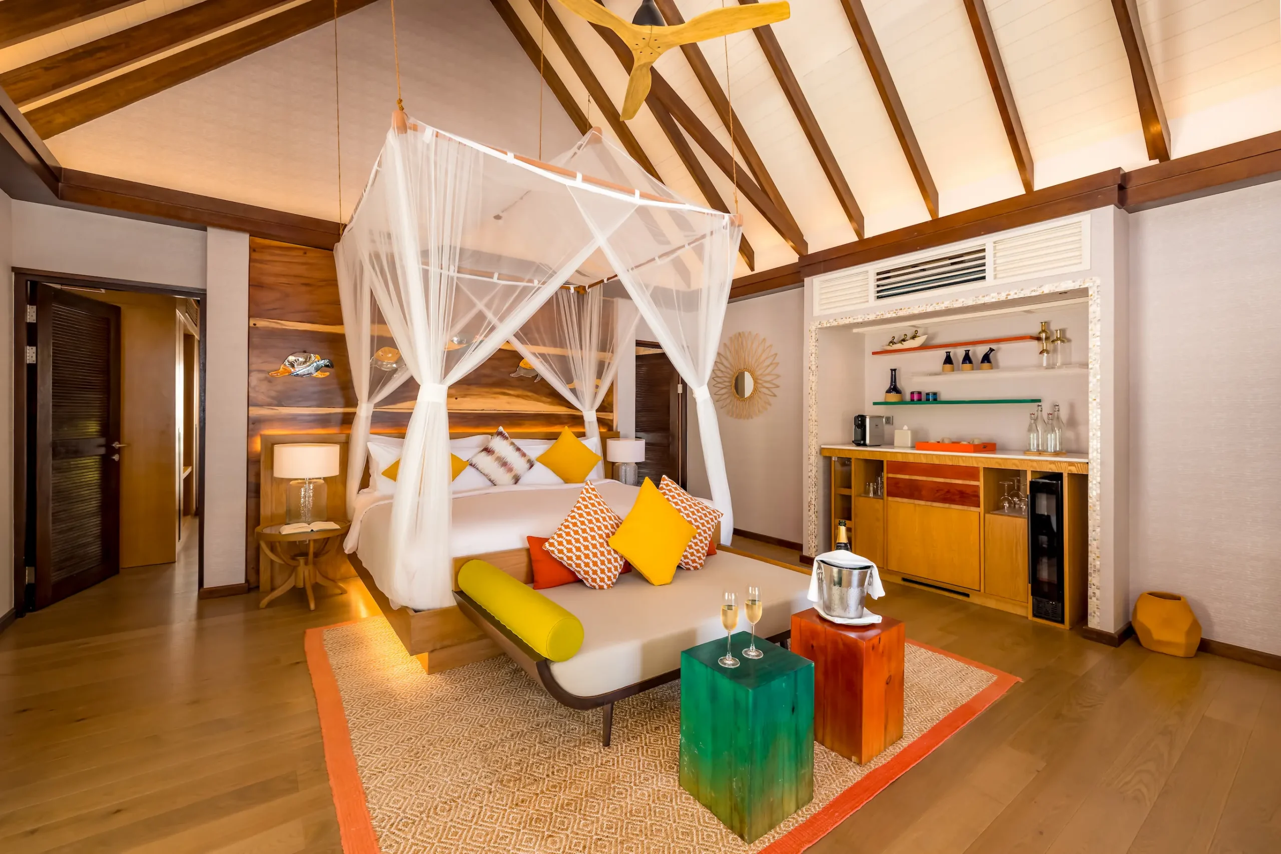 Contemporary Earth Villa bedroom at OZEN LIFE MAADHOO with high vaulted ceilings, elegant furnishings and a spacious layout opening towards the outdoor living area.
