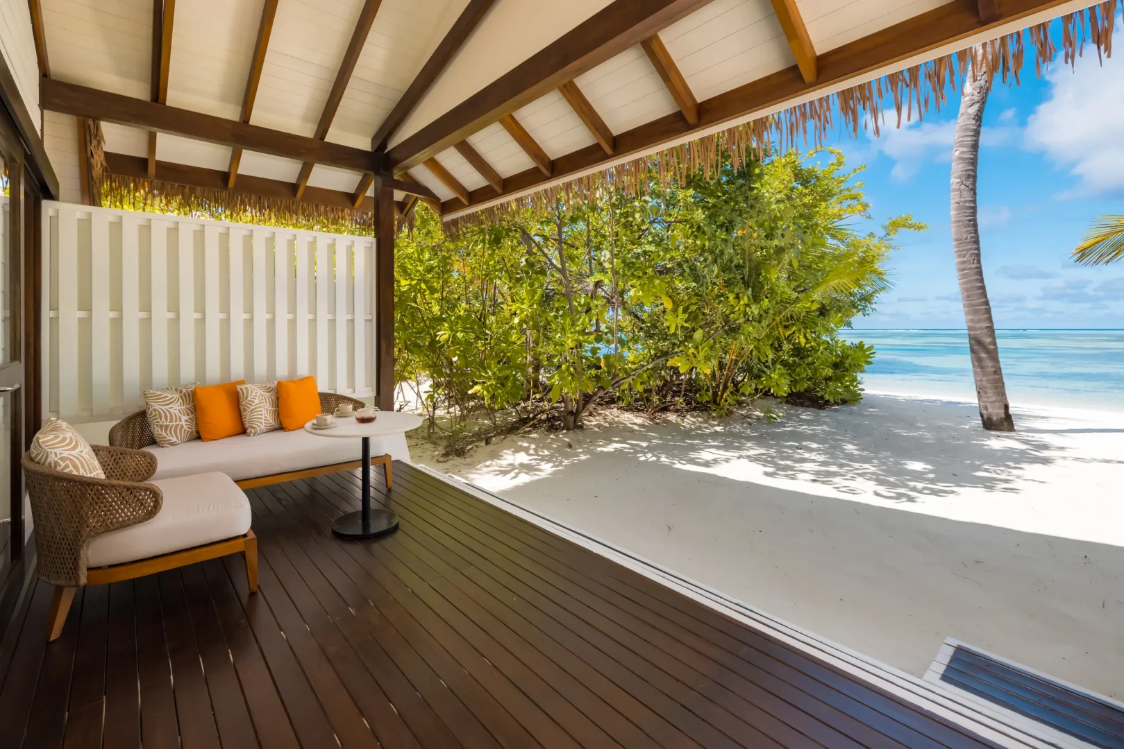 Private outdoor deck at an Earth Villa at OZEN LIFE MAADHOO, offering a spacious area for relaxation with direct access to the beach.